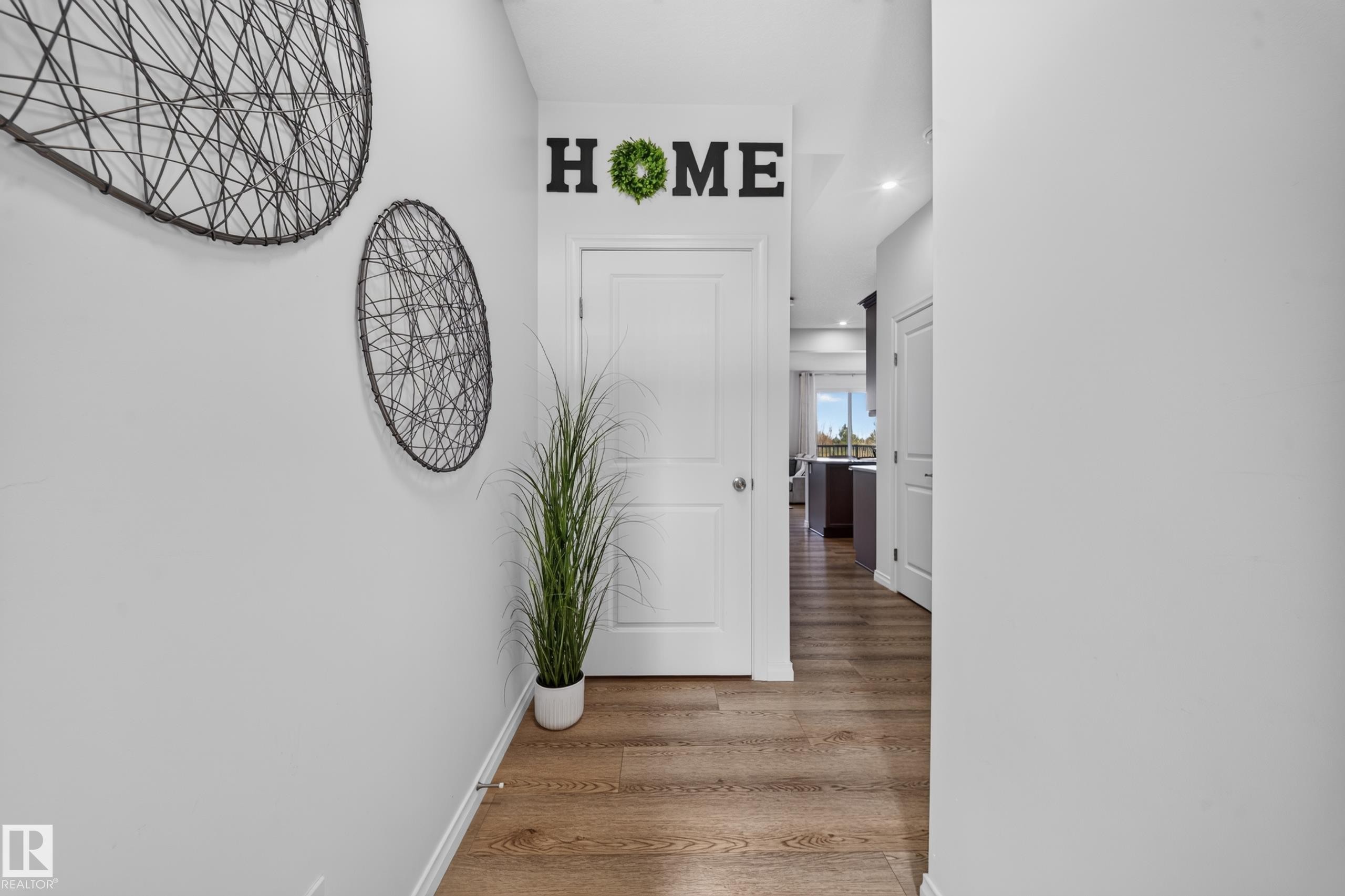 Wood-finish flooring with white trim - 4104 3 Avenue Sw, Edmonton, AB