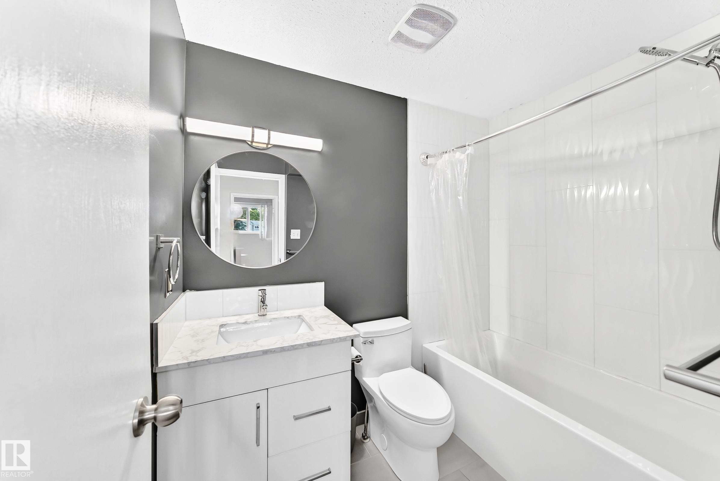 White vanity with a stone-finish countertop and undermount sink - 44 Habitat Crescent Nw, Edmonton, AB