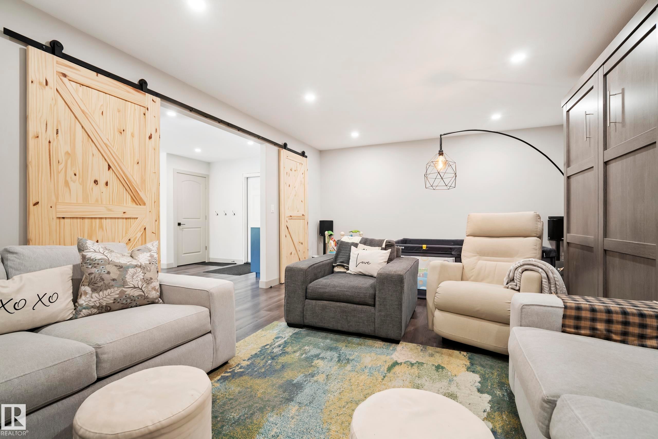 Wood-finish flooring, recessed lighting, and a built-in wall unit - 49279 Rge Rd 240, Rural Leduc County, AB
