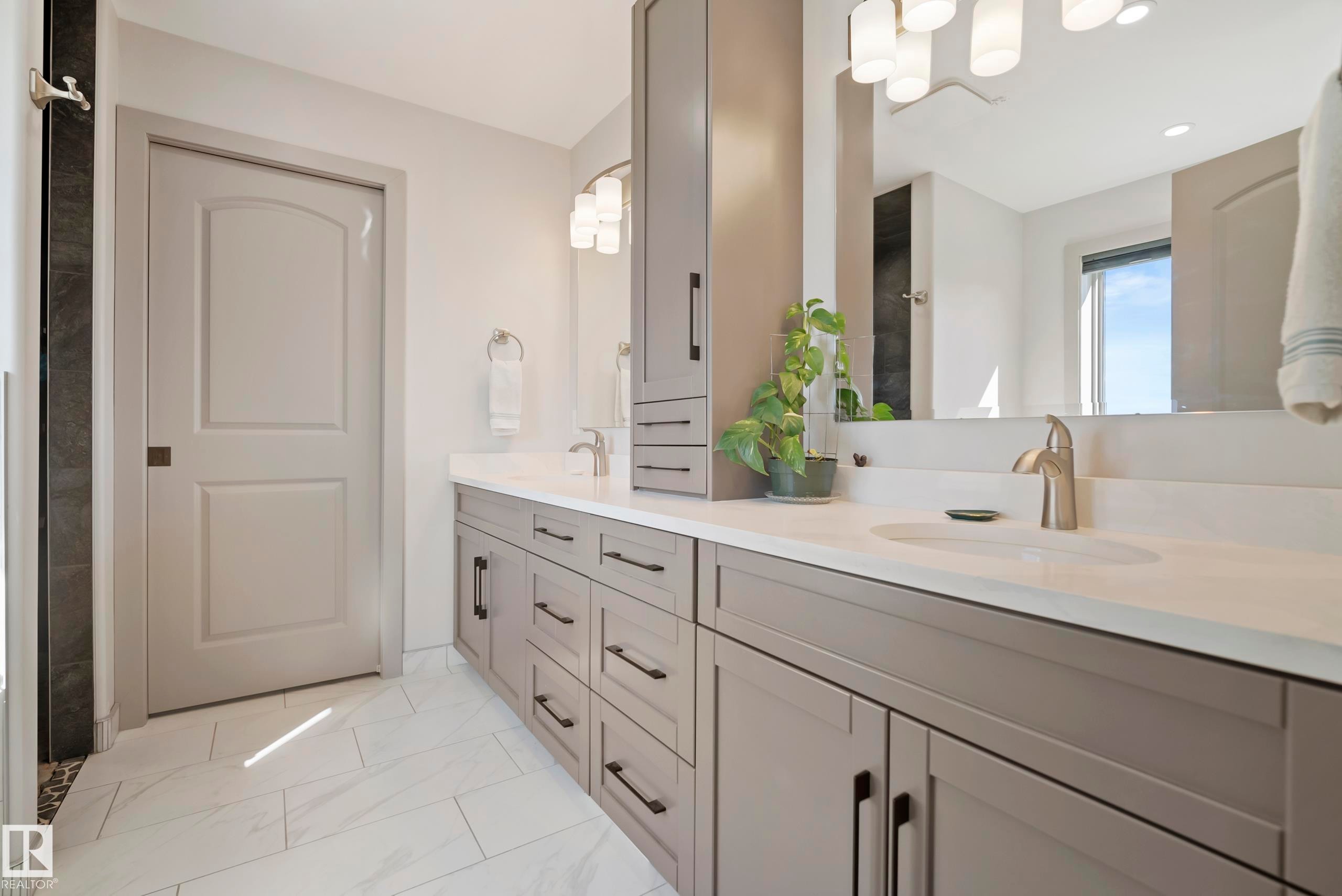 Dual vanity with light gray cabinetry, white countertops, and undermount sinks - 49279 Rge Rd 240, Rural Leduc County, AB