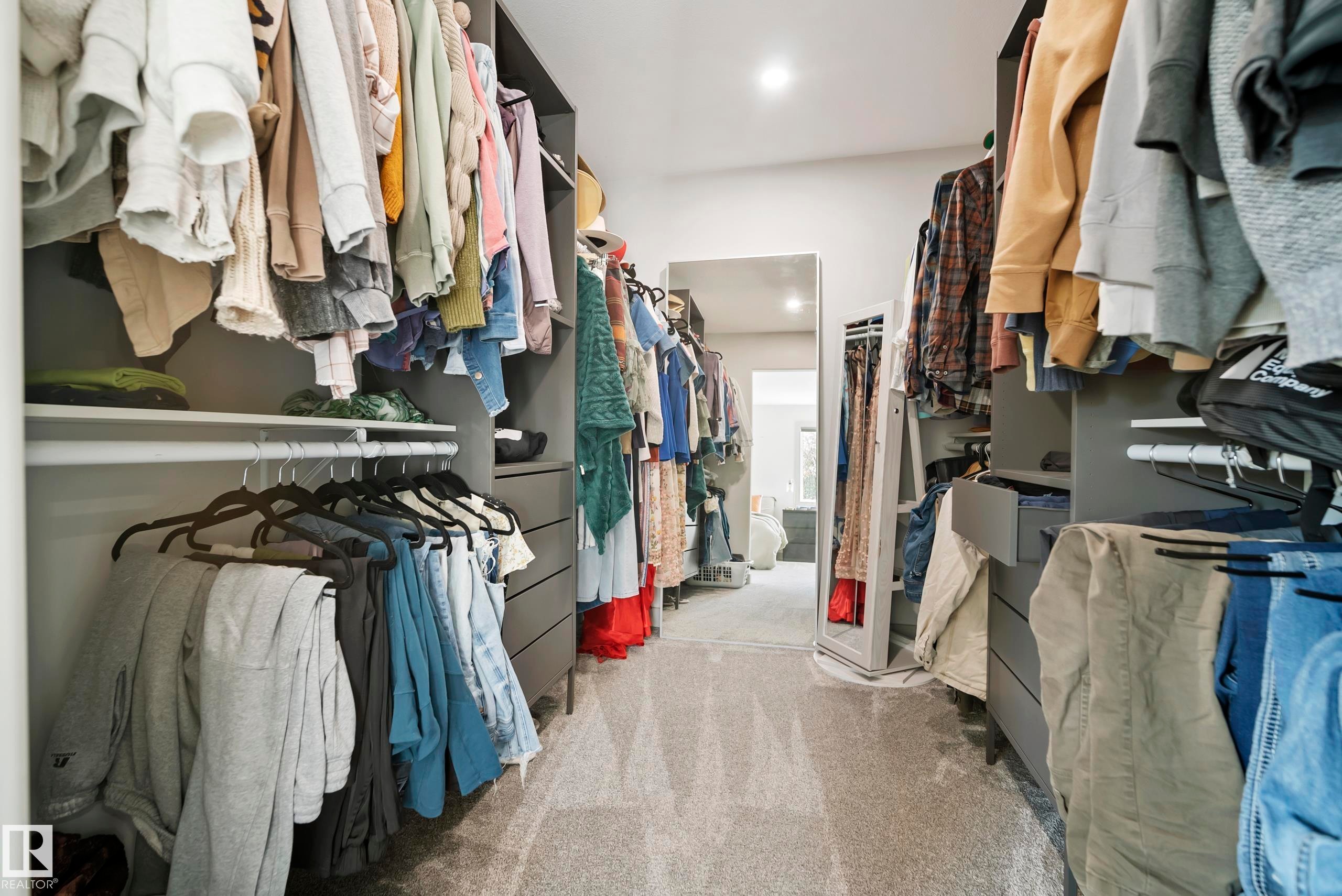 Walk-in closet featuring built-in cabinetry, recessed lighting, and carpet flooring - 49279 Rge Rd 240, Rural Leduc County, AB
