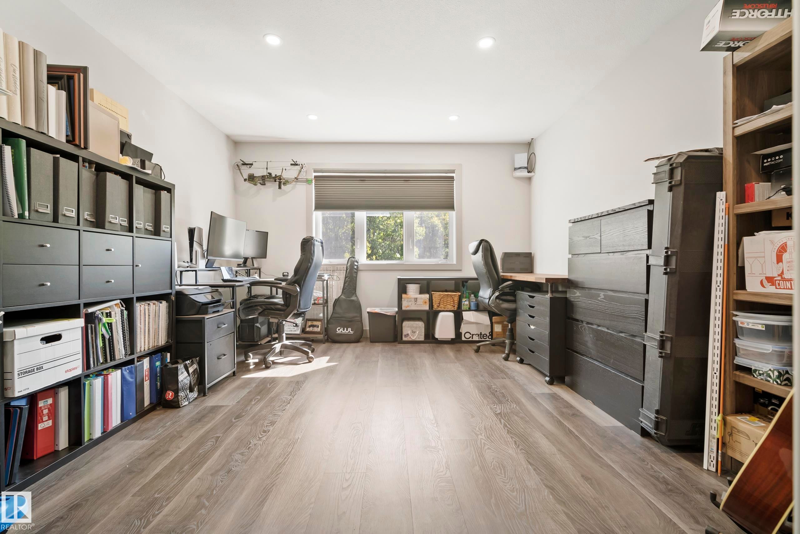 Wood-finish flooring with recessed lighting and a window featuring a roller shade - 49279 Rge Rd 240, Rural Leduc County, AB