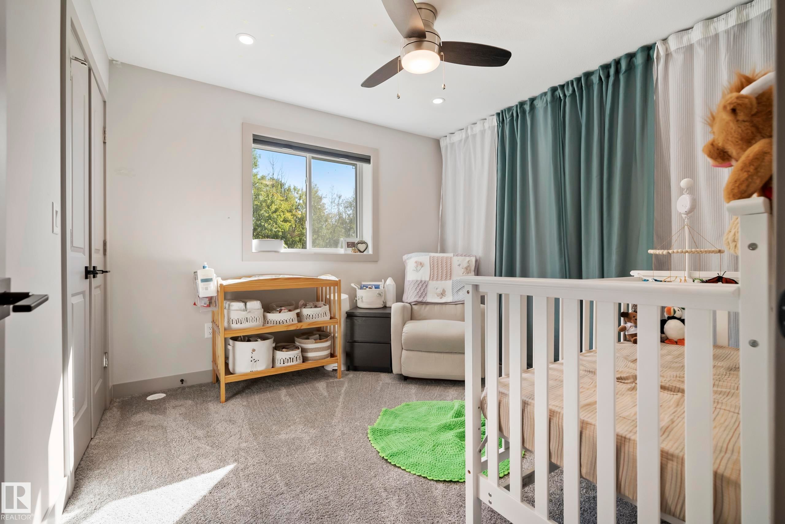 Recessed lighting, ceiling fan with light, large window, and wall-mounted curtain rod with drapes - 49279 Rge Rd 240, Rural Leduc County, AB