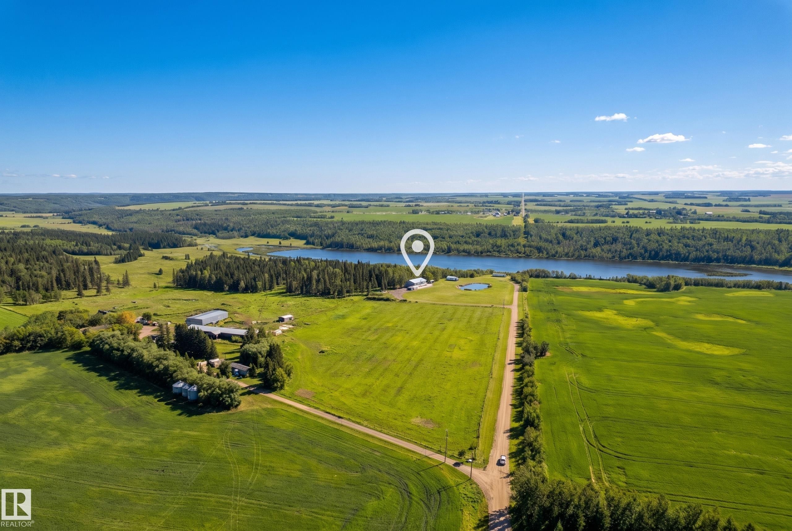 Expansive green fields, abundant natural landscaping, and substantial water features - 49279 Rge Rd 240, Rural Leduc County, AB