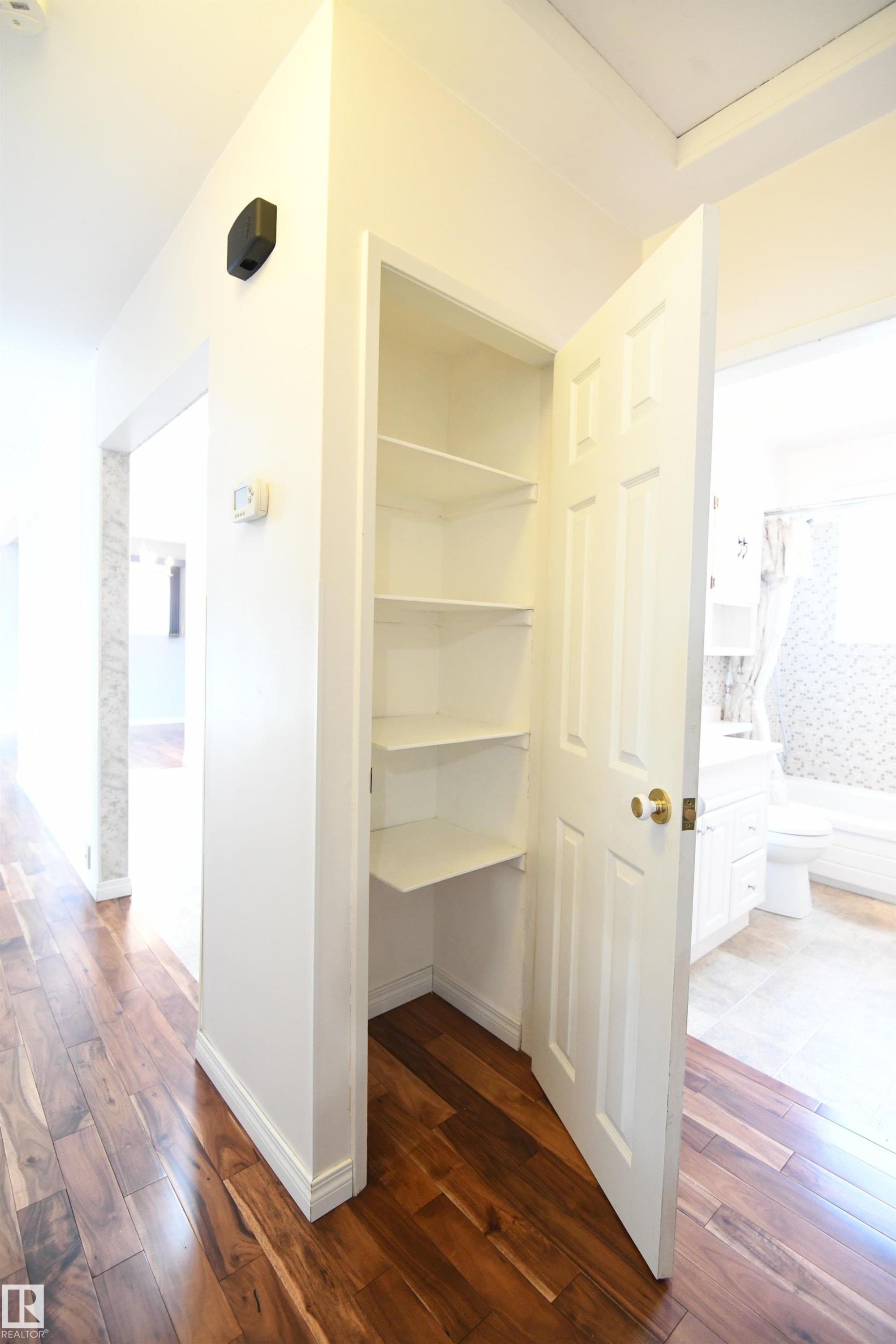 The linen closet is located by the bedrooms and the main 4 piece bathroom. Sometimes the little details say a lot. The shelves in this closet are prepped to also store a broom and dustpan, testimony to the care and pride that the owners have taken here - 10243 42 Street Nw, Edmonton, AB