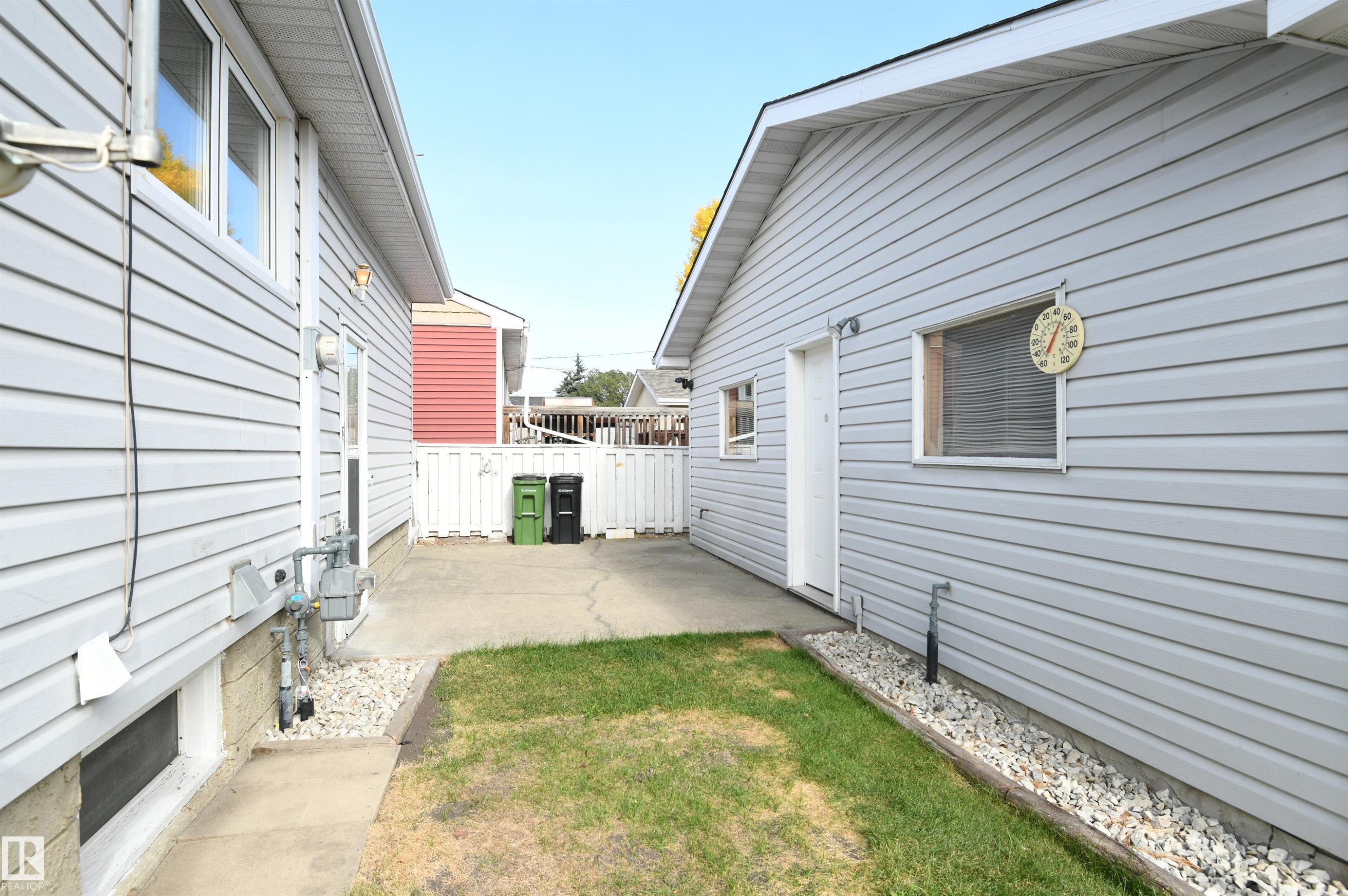 The patio is just outside of the rear door of the home, and connects to the oversized, heated garage. Perfect for a patio sitting area, with a gas barbecue connection. Maybe even add a pergola between the two structures for a modern touch - 10243 42 Street Nw, Edmonton, AB