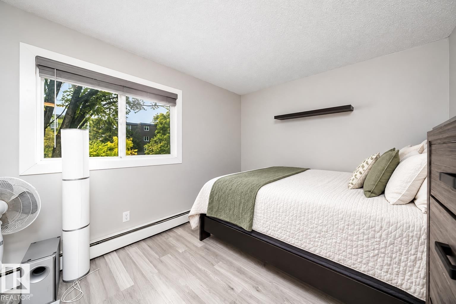 Light gray walls, wood-finish flooring, and a window with blinds - #202 10615 156 St Nw, Edmonton, AB
