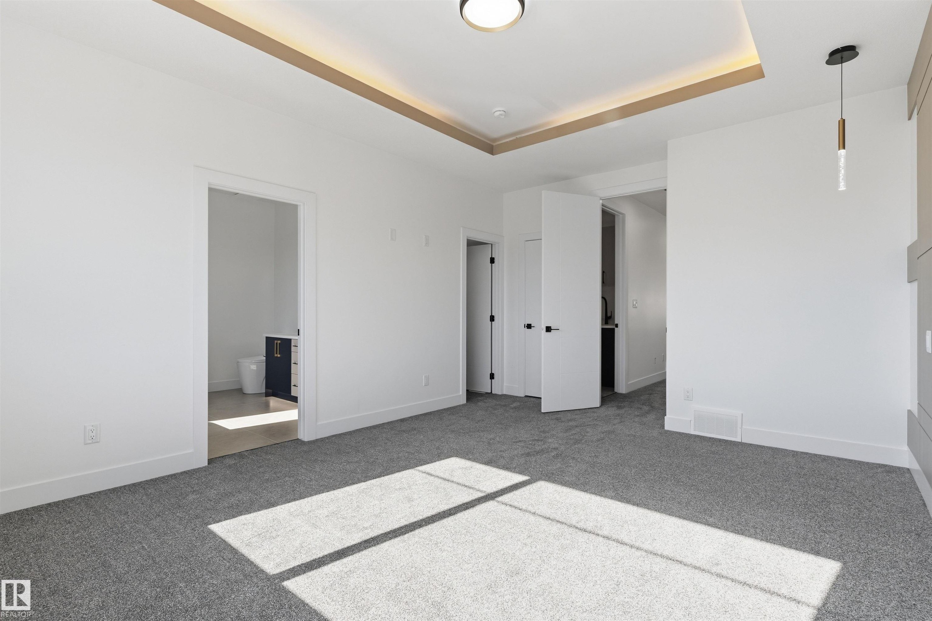 Recessed ceiling with perimeter lighting, ceiling-mounted light fixture, pendant light fixture, and gray textured carpeting - 2720 63 Avenue, Rural Leduc County, AB