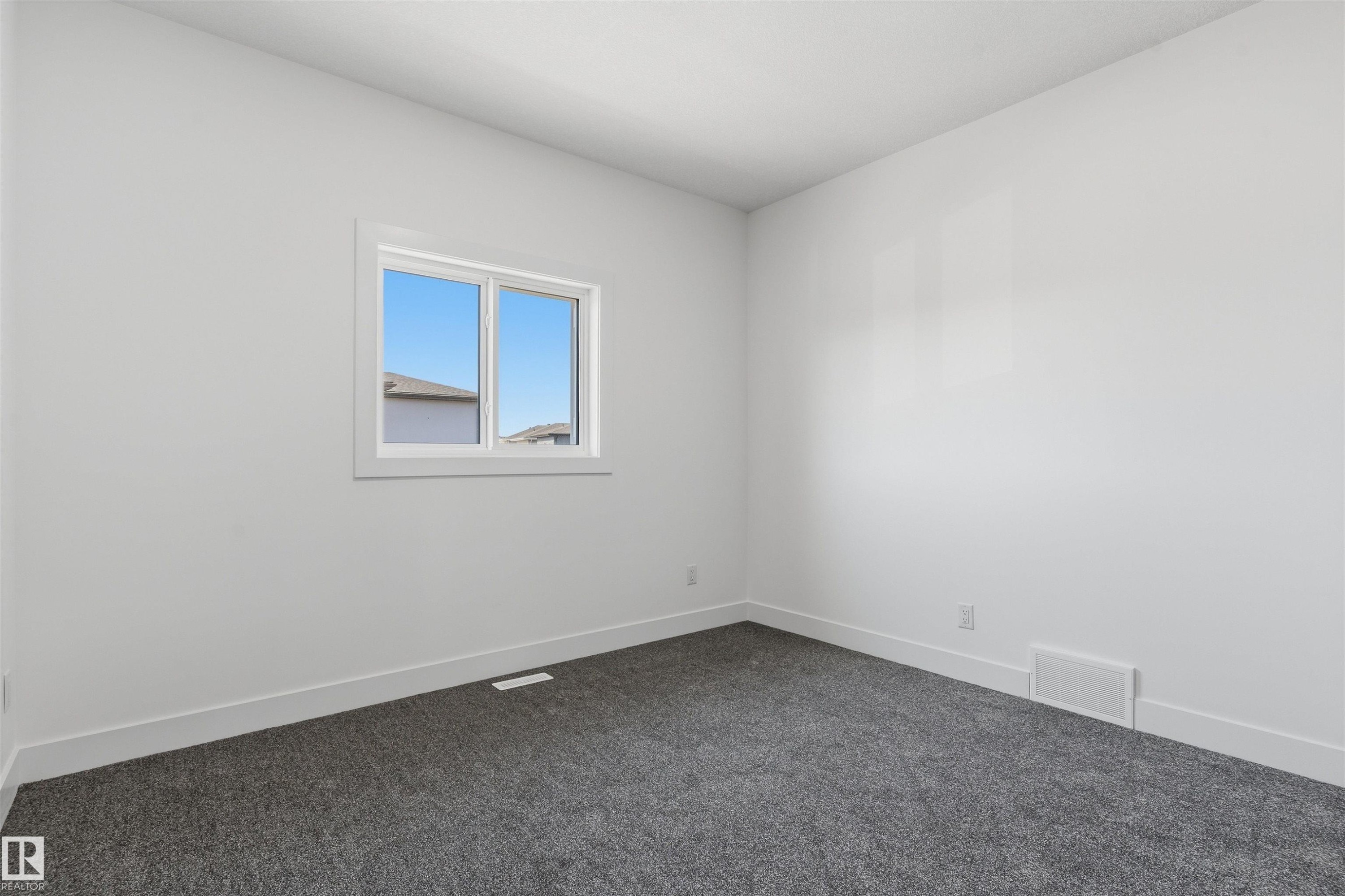 Light gray wall paint, white trim, and gray carpeted flooring - 2720 63 Avenue, Rural Leduc County, AB