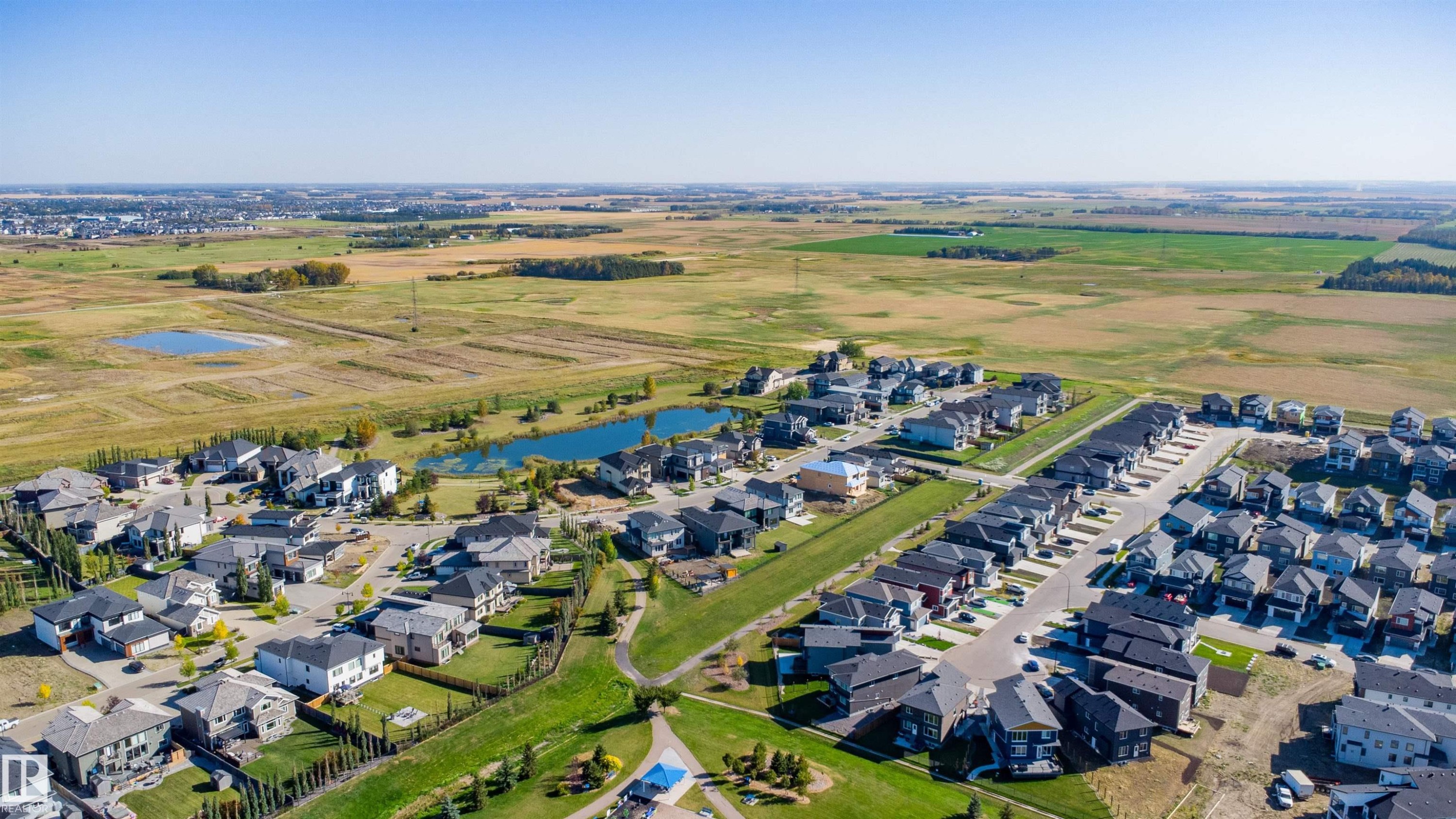 Residential community with varied architectural styles, green spaces, and a pond feature - 2720 63 Avenue, Rural Leduc County, AB