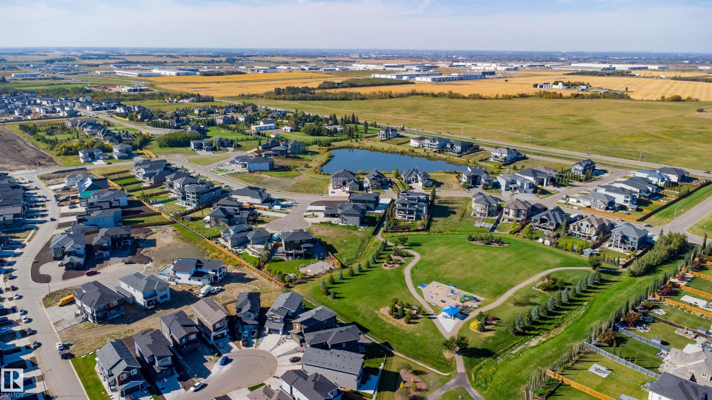 Residential development featuring a central green space, water feature, and a variety of architectural styles - 2720 63 Avenue, Rural Leduc County, AB