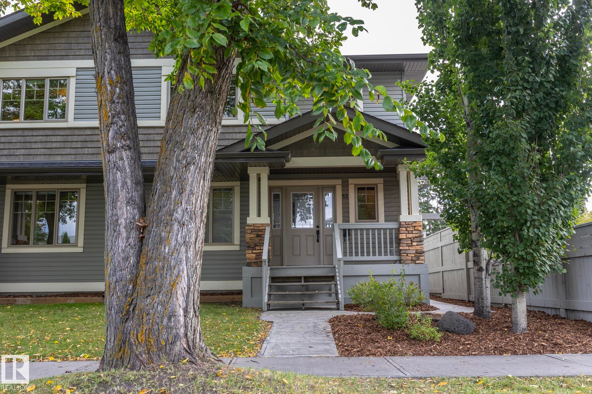 Two-story residence featuring gray siding and shingle accents - 55 Michigan Street, Devon, AB