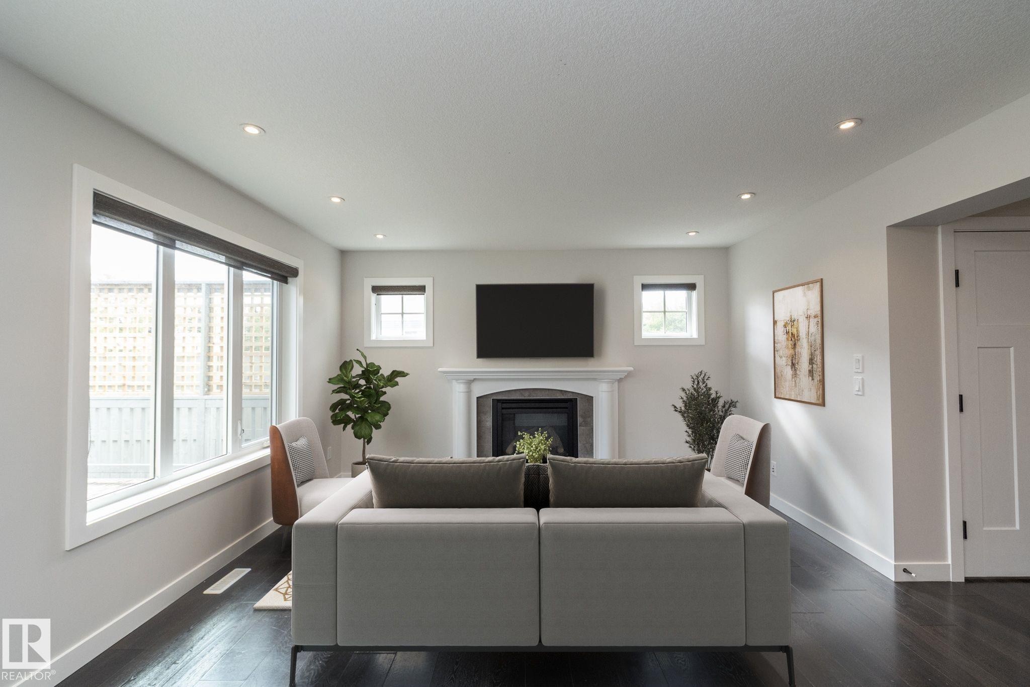 Recessed ceiling lighting, dark wood-finish flooring, and white trim - 55 Michigan Street, Devon, AB
