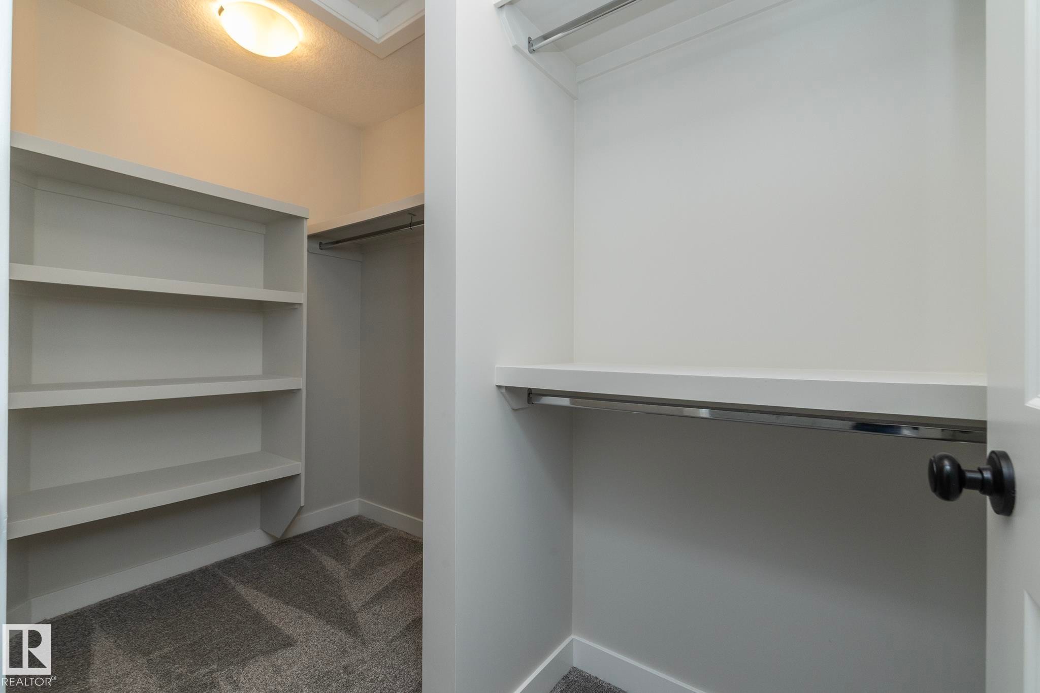 Built-in shelving, two clothing rods, and textured carpeting - 55 Michigan Street, Devon, AB