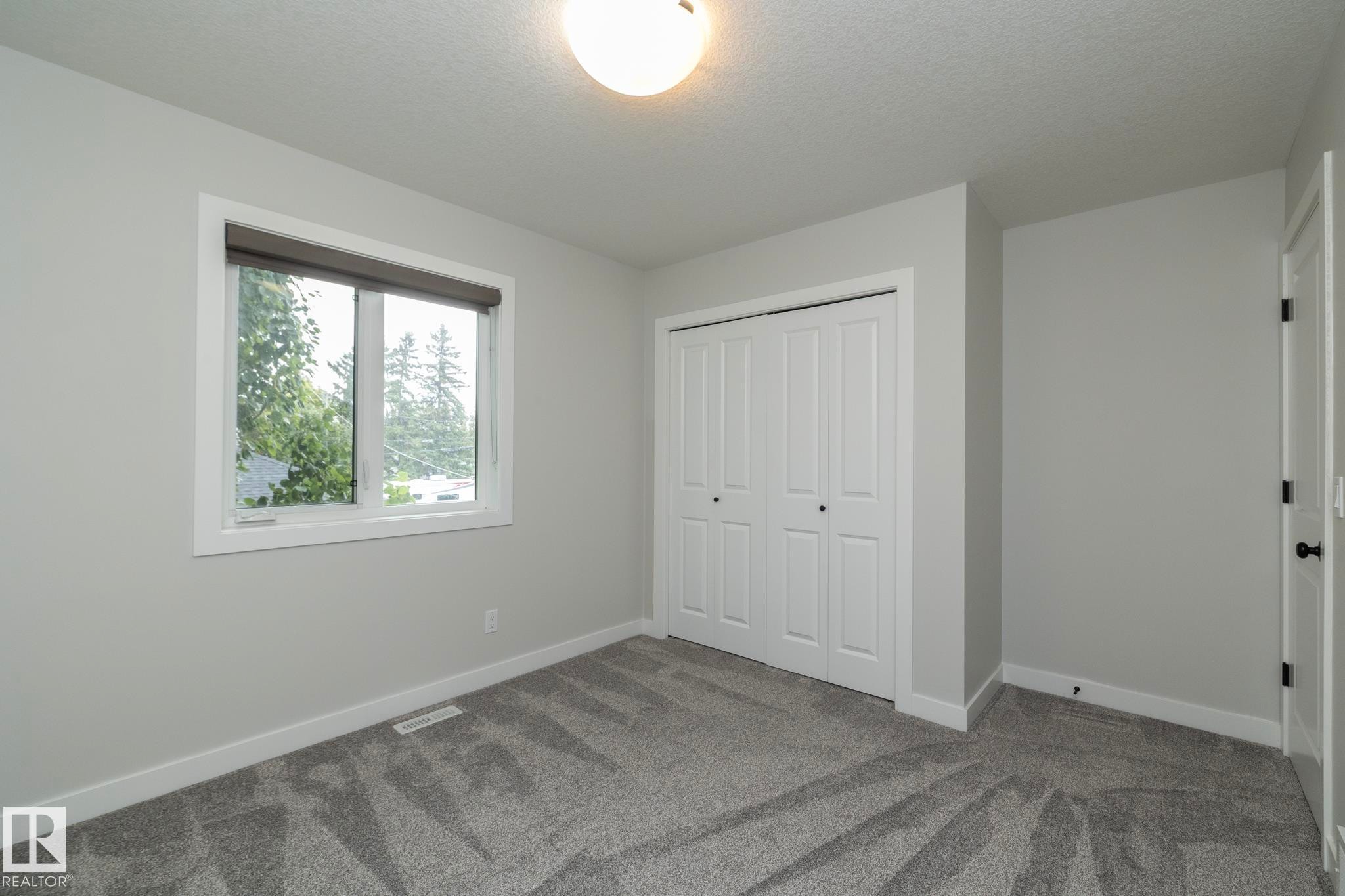 Plush carpeting and light gray wall paint - 55 Michigan Street, Devon, AB
