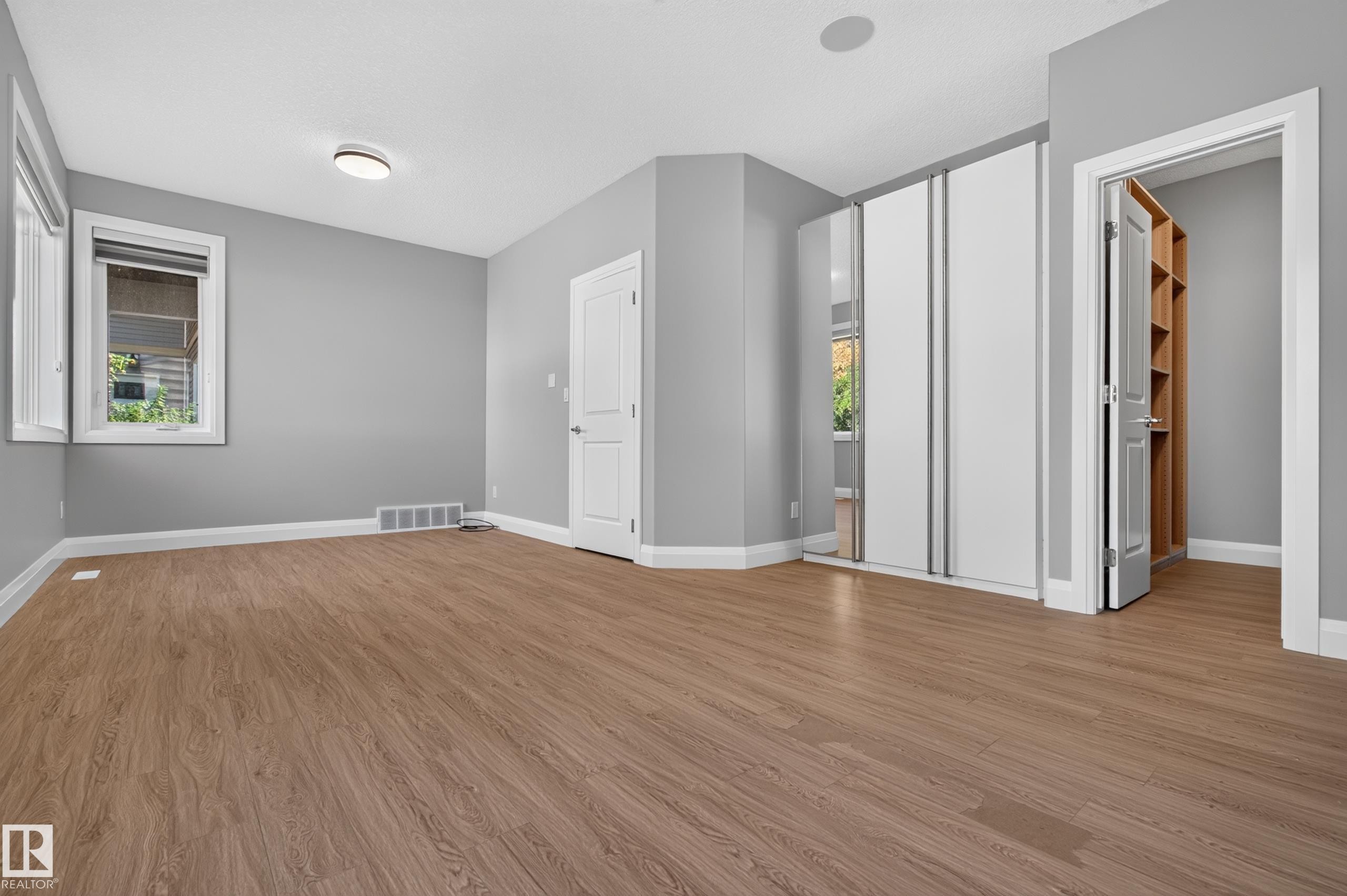 Wood-finish flooring, white trim, recessed lighting, and built-in closet shelving - 11167 62 Avenue Nw, Edmonton, AB