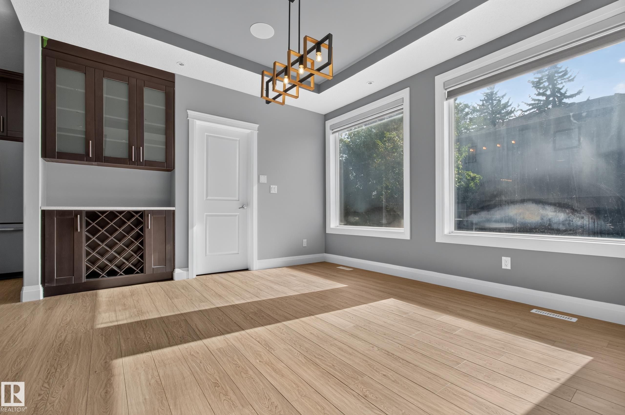 Built-in cabinetry with glass-front uppers and a dedicated wine rack - 11167 62 Avenue Nw, Edmonton, AB