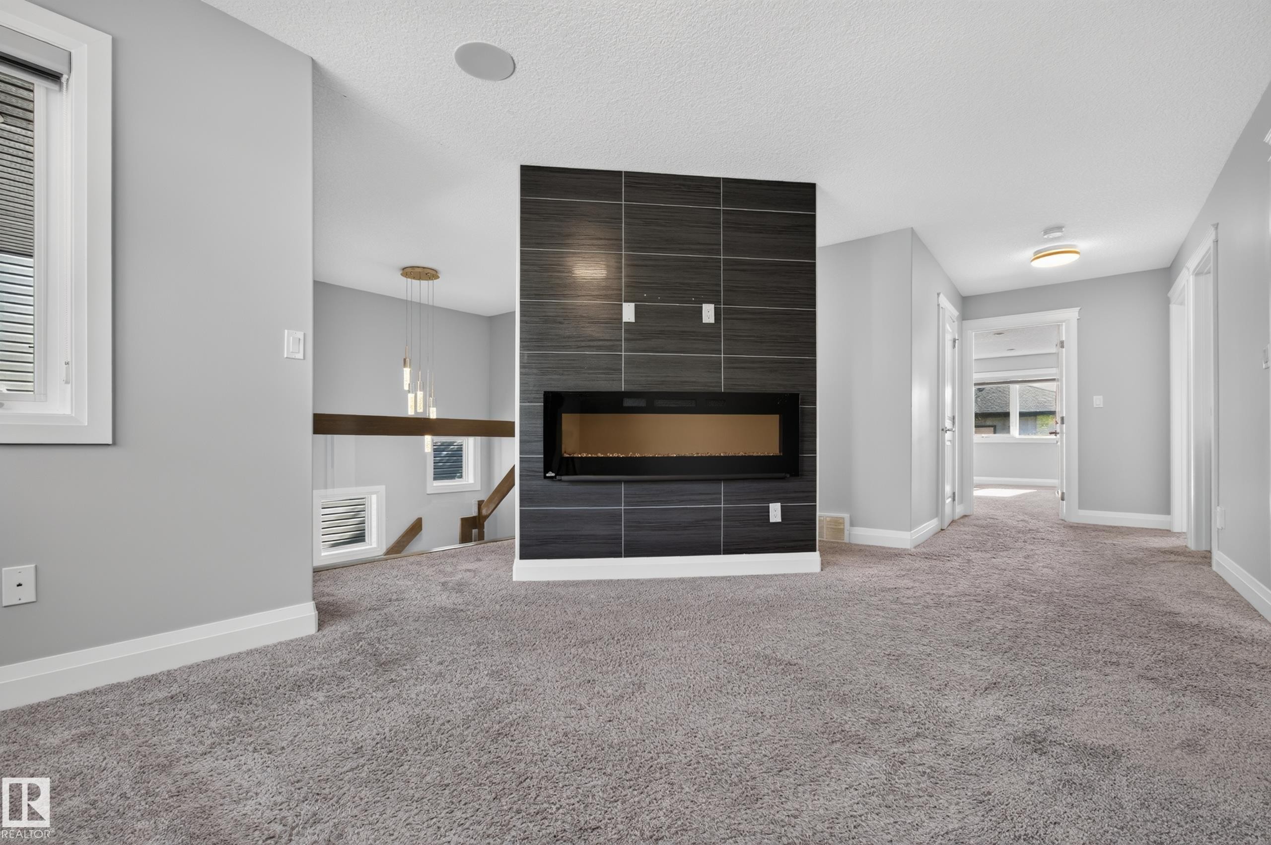 Linear electric fireplace with a dark tile surround - 11167 62 Avenue Nw, Edmonton, AB