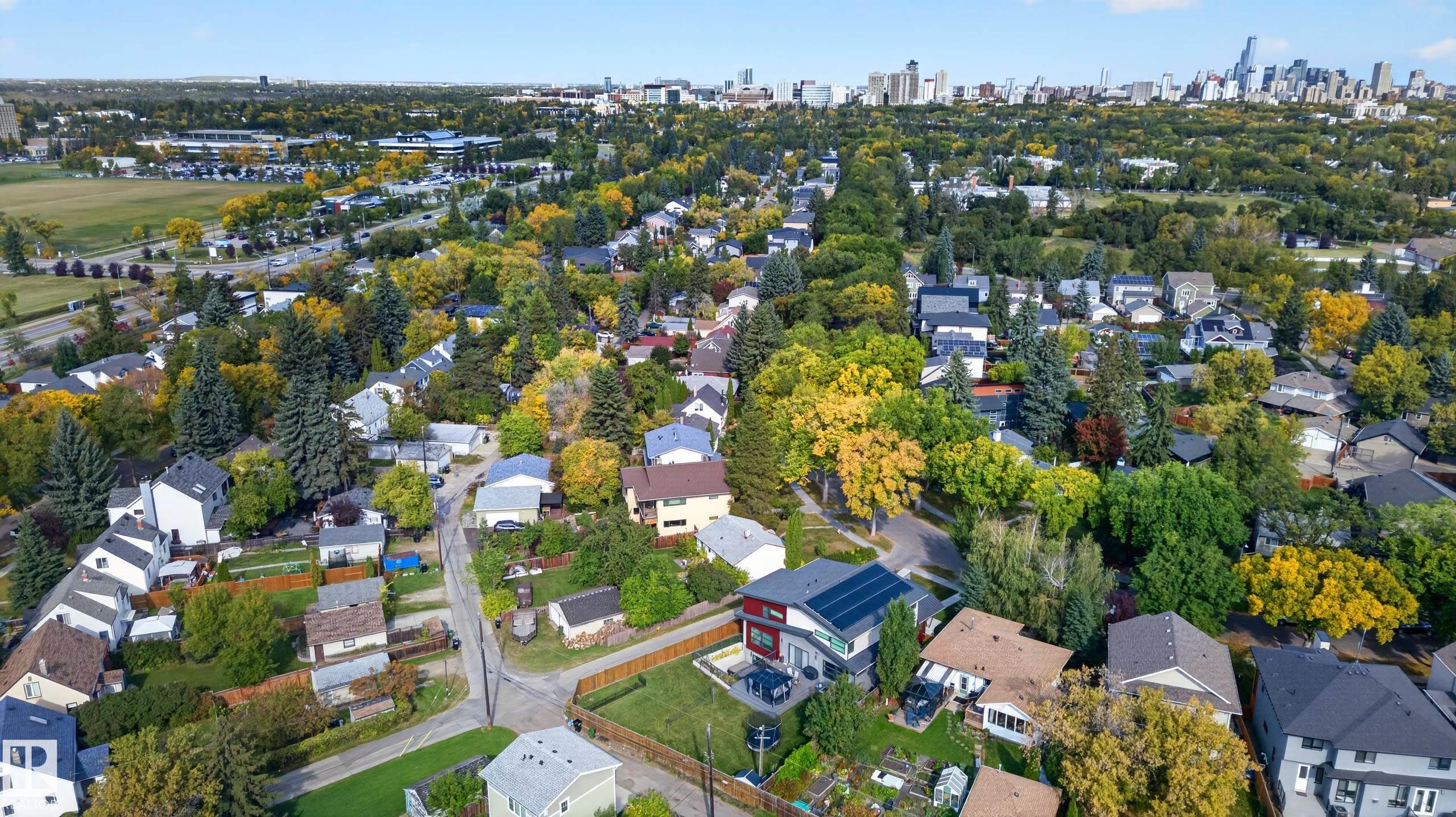 Residential neighborhood with mature trees, established streets, and a distant city skyline - 11167 62 Avenue Nw, Edmonton, AB