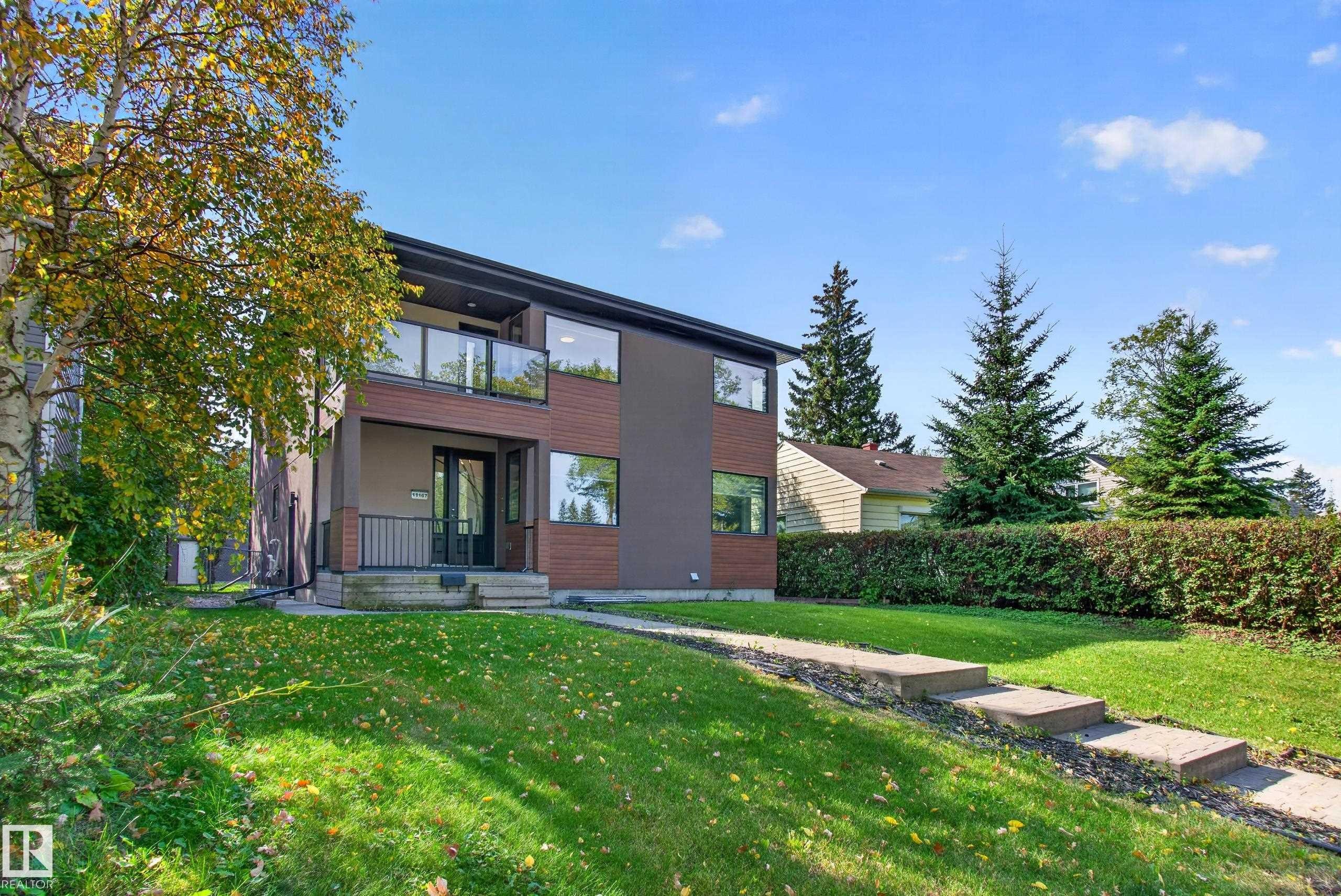 Modern exterior with dark-toned siding and wood-finish accents - 11167 62 Avenue Nw, Edmonton, AB