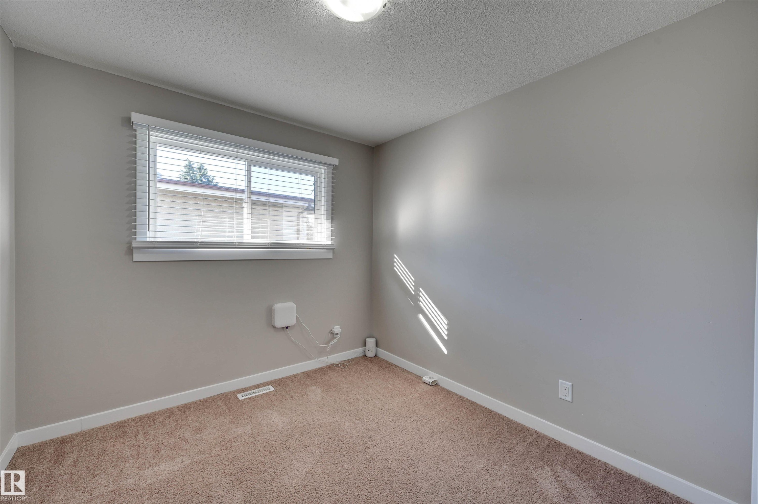 Neutral wall paint, window with horizontal blinds, and carpet flooring - 13815 88 Street Nw, Edmonton, AB