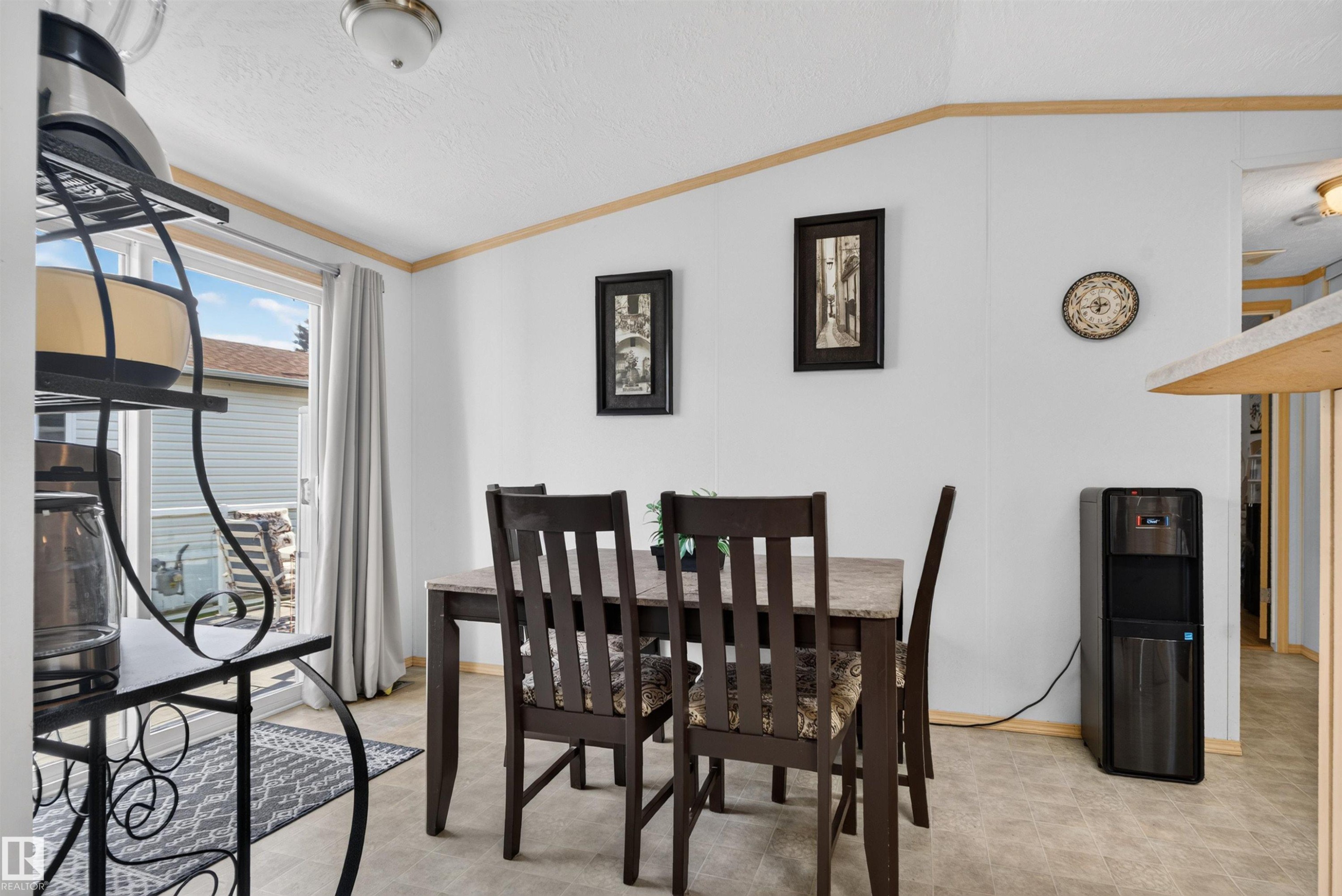 Sliding glass door, durable flooring, ceiling-mounted light fixture, wood-finish trim, and white wall panels - 1405 53222 Range Road 272, Rural Parkland County, AB