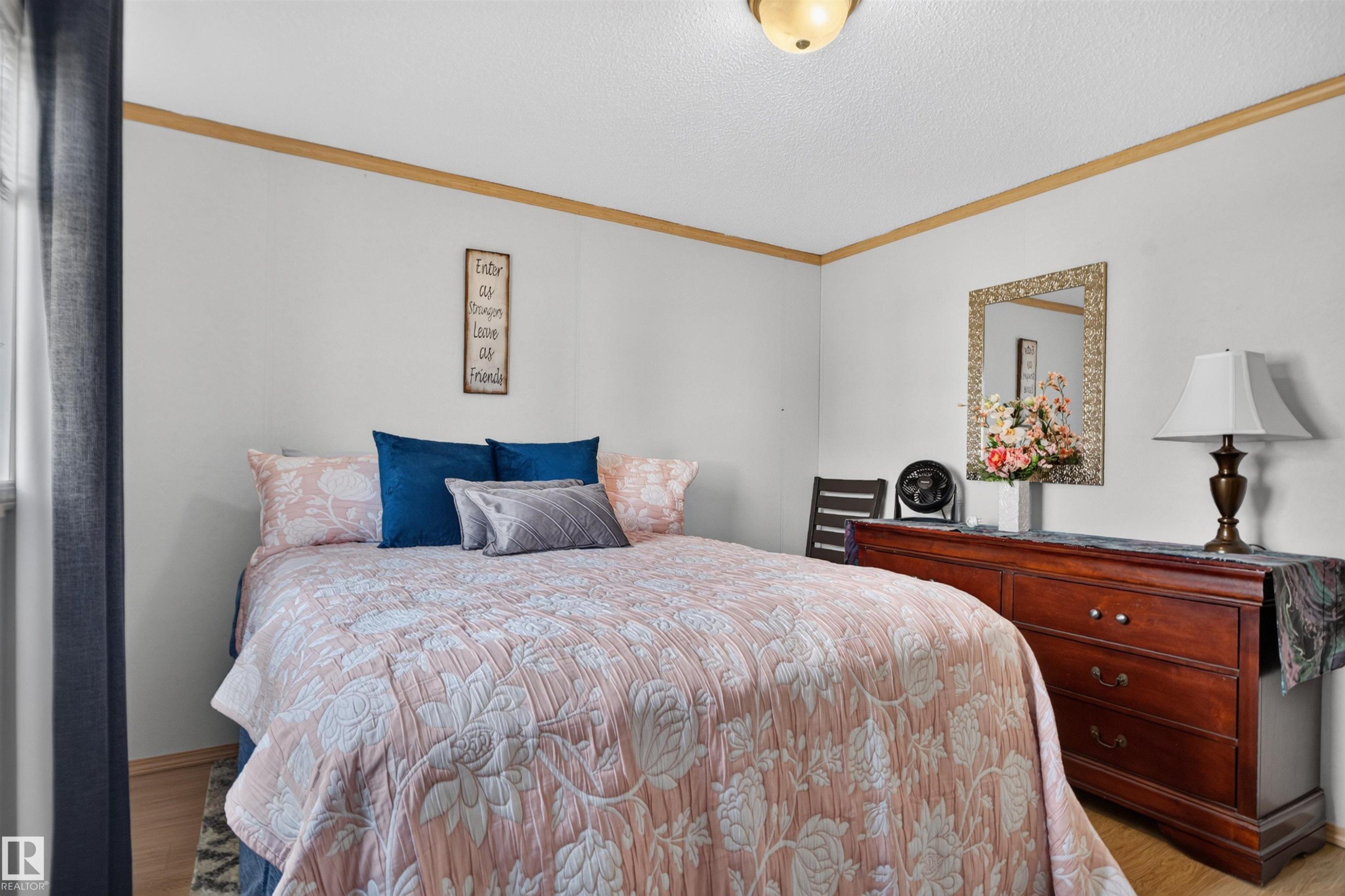 Wood-finish flooring with light-toned walls and crown molding - 1405 53222 Range Road 272, Rural Parkland County, AB