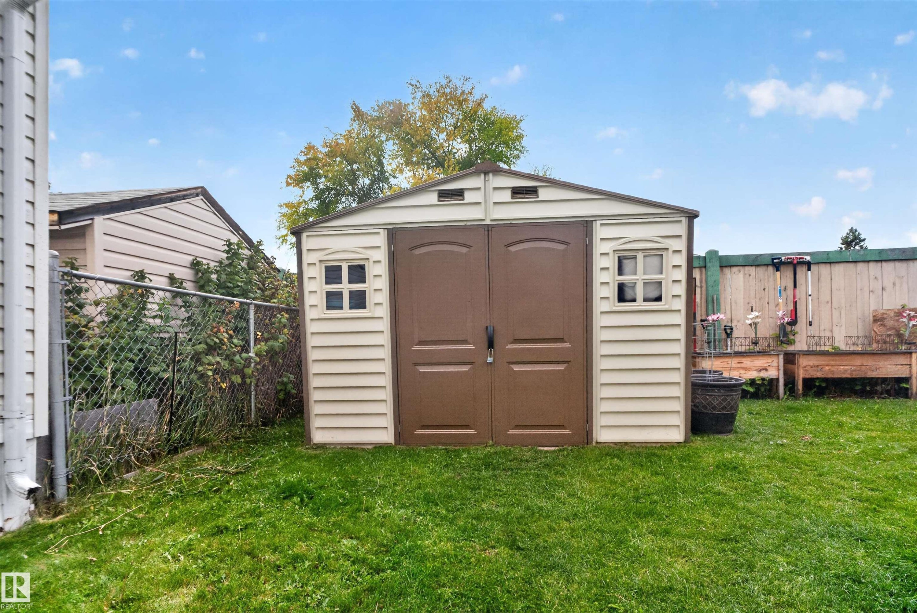 Utility shed with double doors, side windows, and a gabled roof - 1405 53222 Range Road 272, Rural Parkland County, AB