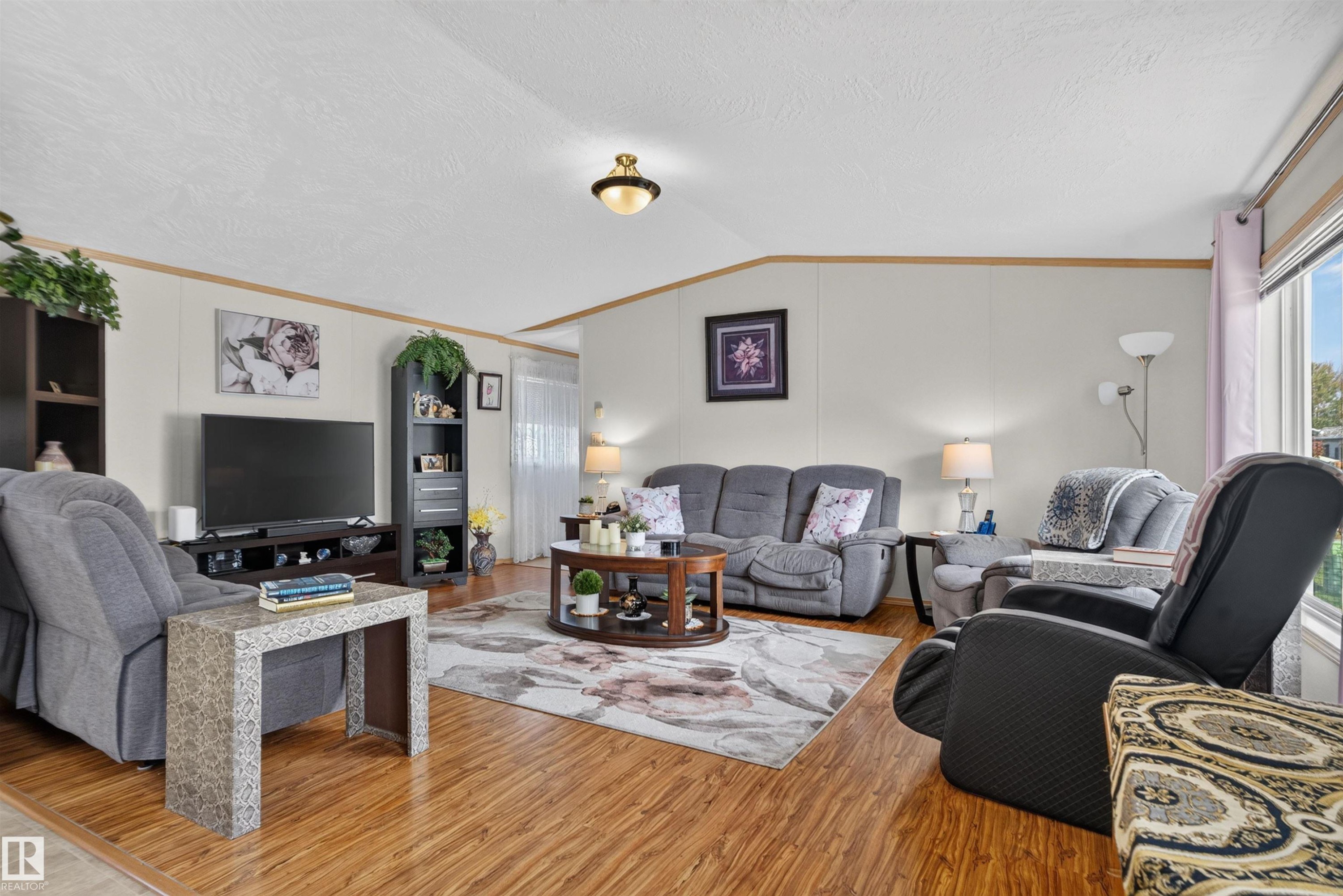 Wood-finish flooring throughout, light-toned walls, and a prominent window providing natural illumination - 1405 53222 Range Road 272, Rural Parkland County, AB