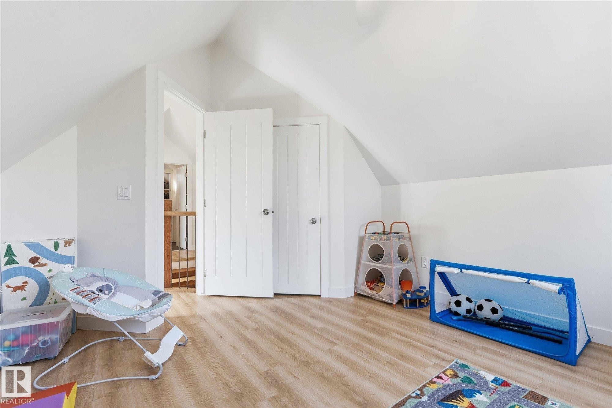 Sloped ceilings, wood-finish flooring, white paneled doors, and a neutral color palette - #45 53122 Rge Road 14, Rural Parkland County, AB