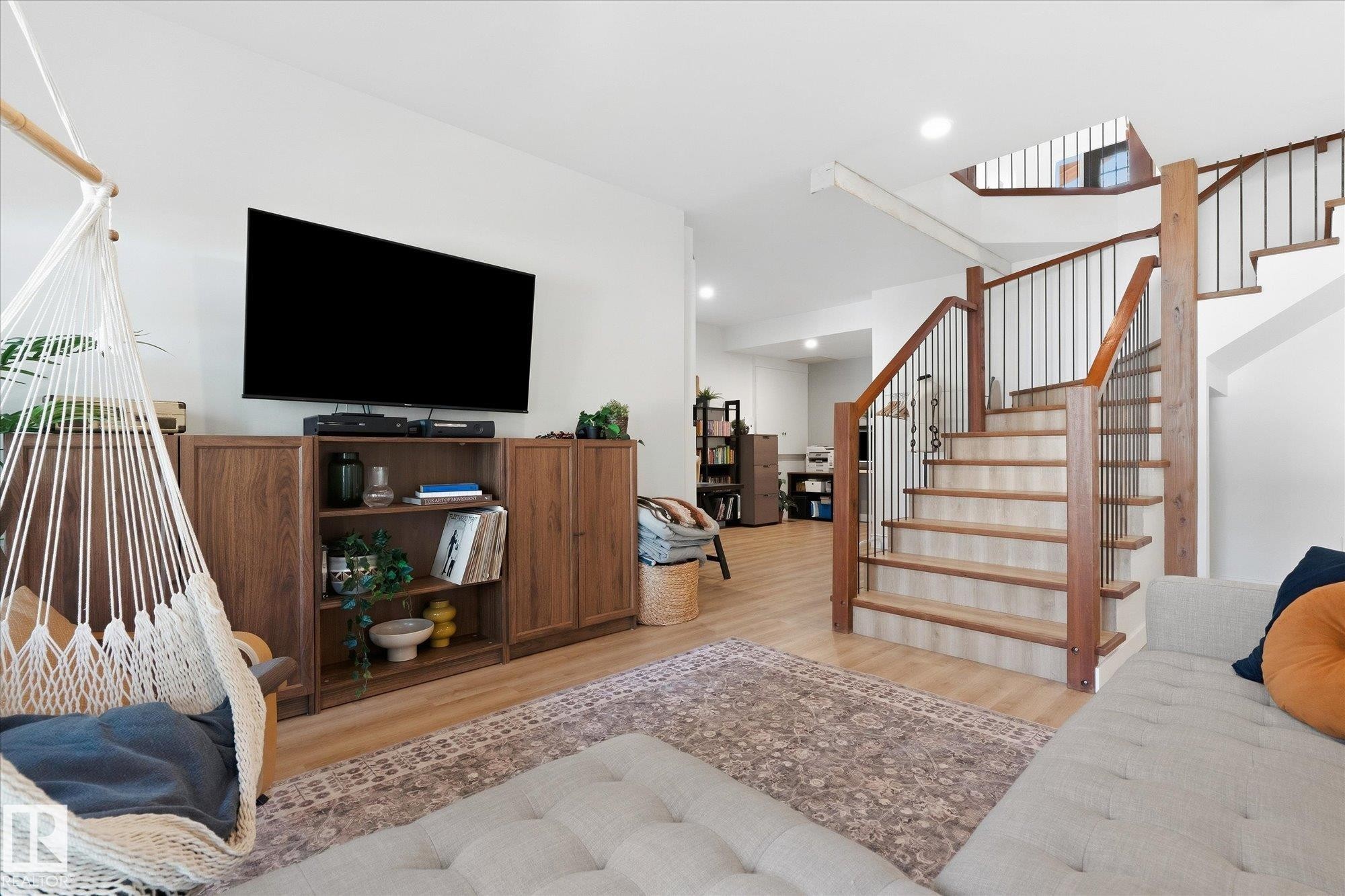 Staircase with wood treads and metal balusters, wood-finish flooring, built-in shelving, recessed lighting, and white walls - #45 53122 Rge Road 14, Rural Parkland County, AB