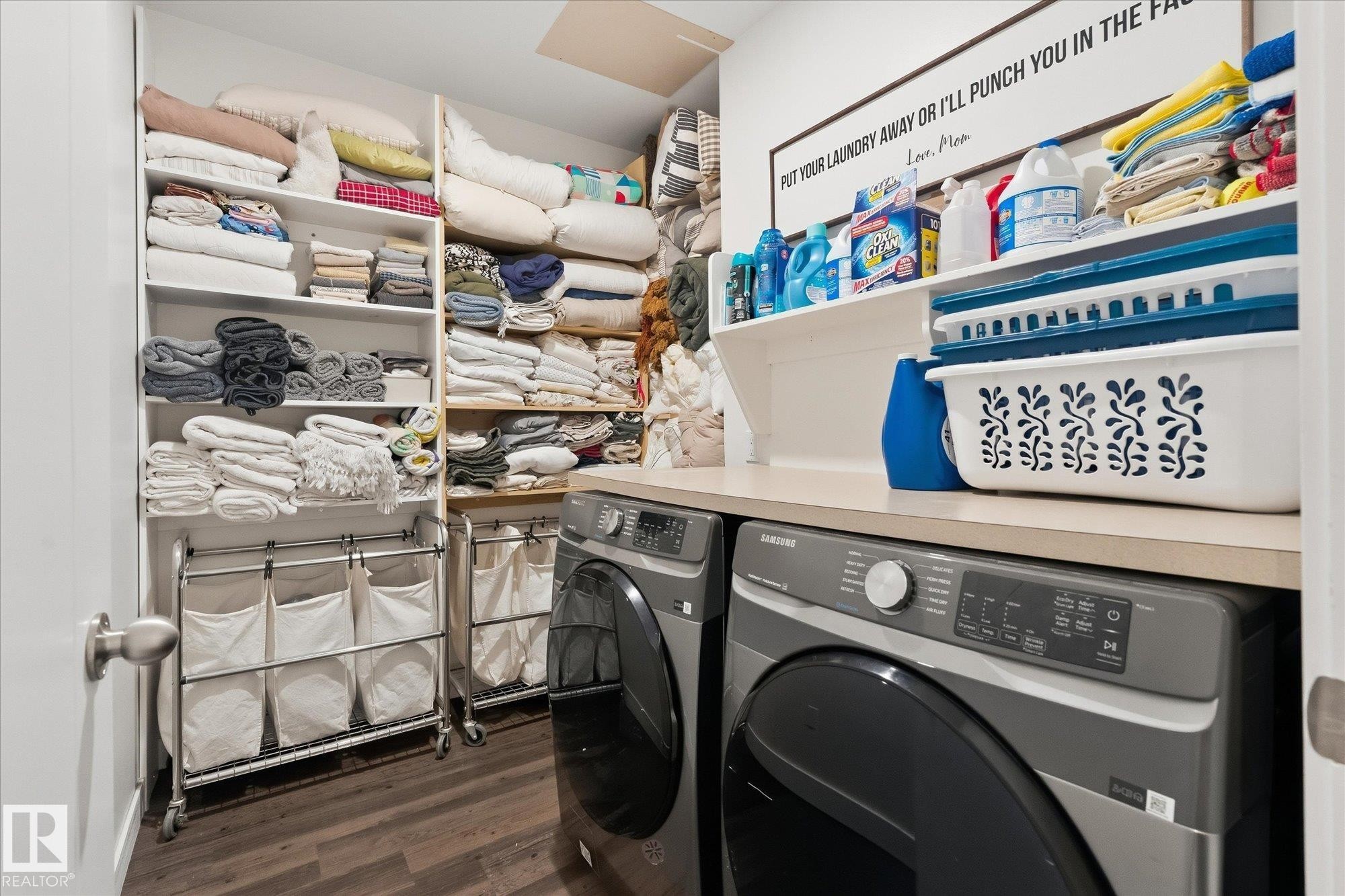 Built-in shelving, wood-finish flooring, light-toned countertop, and integrated washer and dryer - #45 53122 Rge Road 14, Rural Parkland County, AB