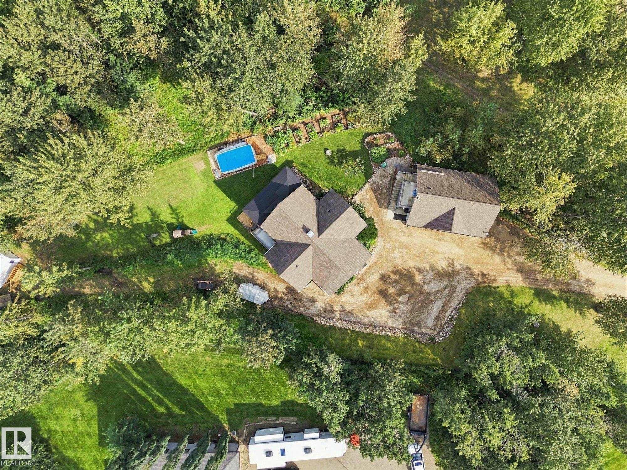 Property with a multi-gabled roofline, an additional structure, and an above-ground pool - #45 53122 Rge Road 14, Rural Parkland County, AB
