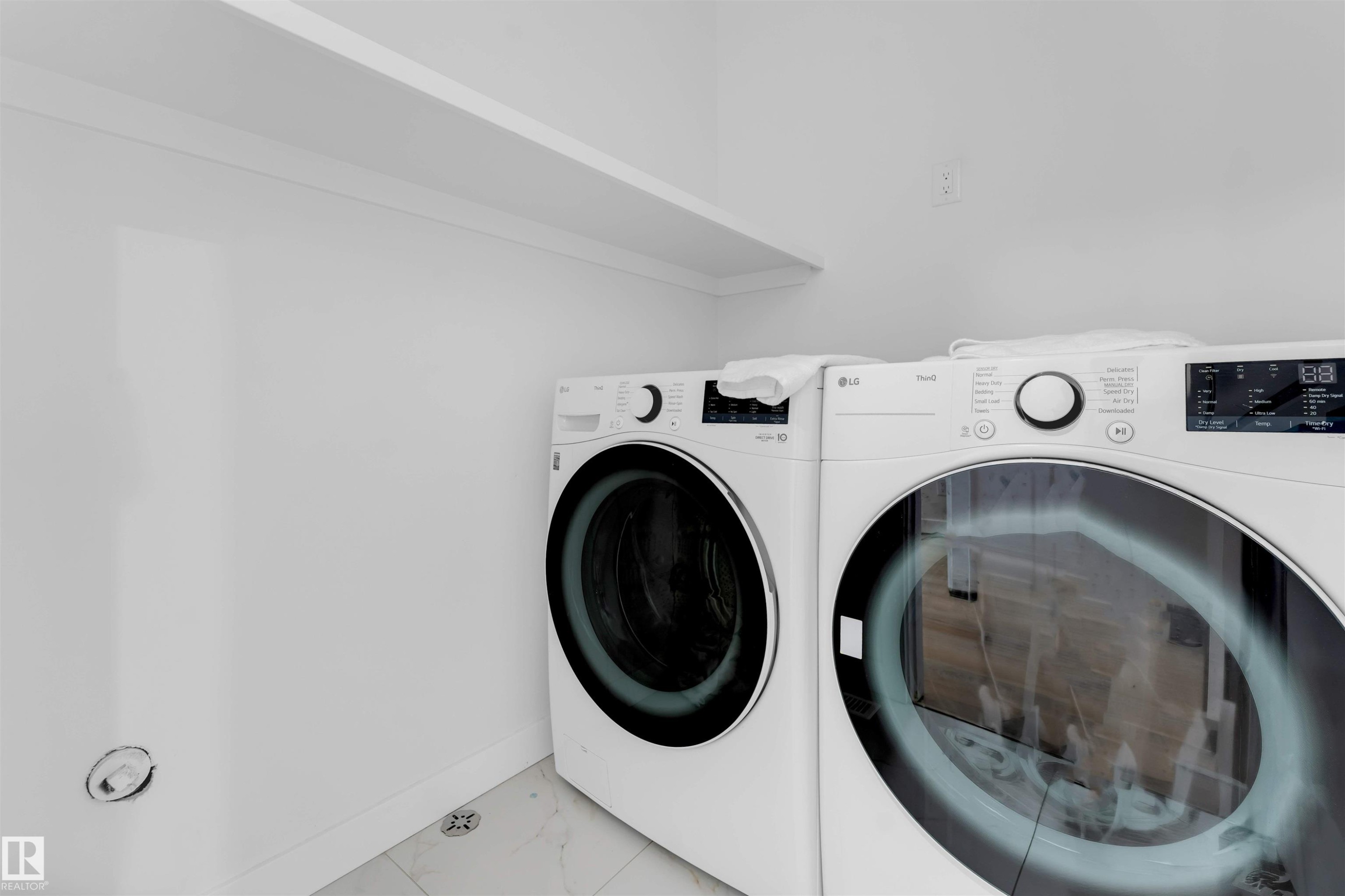Laundry area with an overhead storage shelf and white wall finish - 403 Pine Point, Leduc, AB