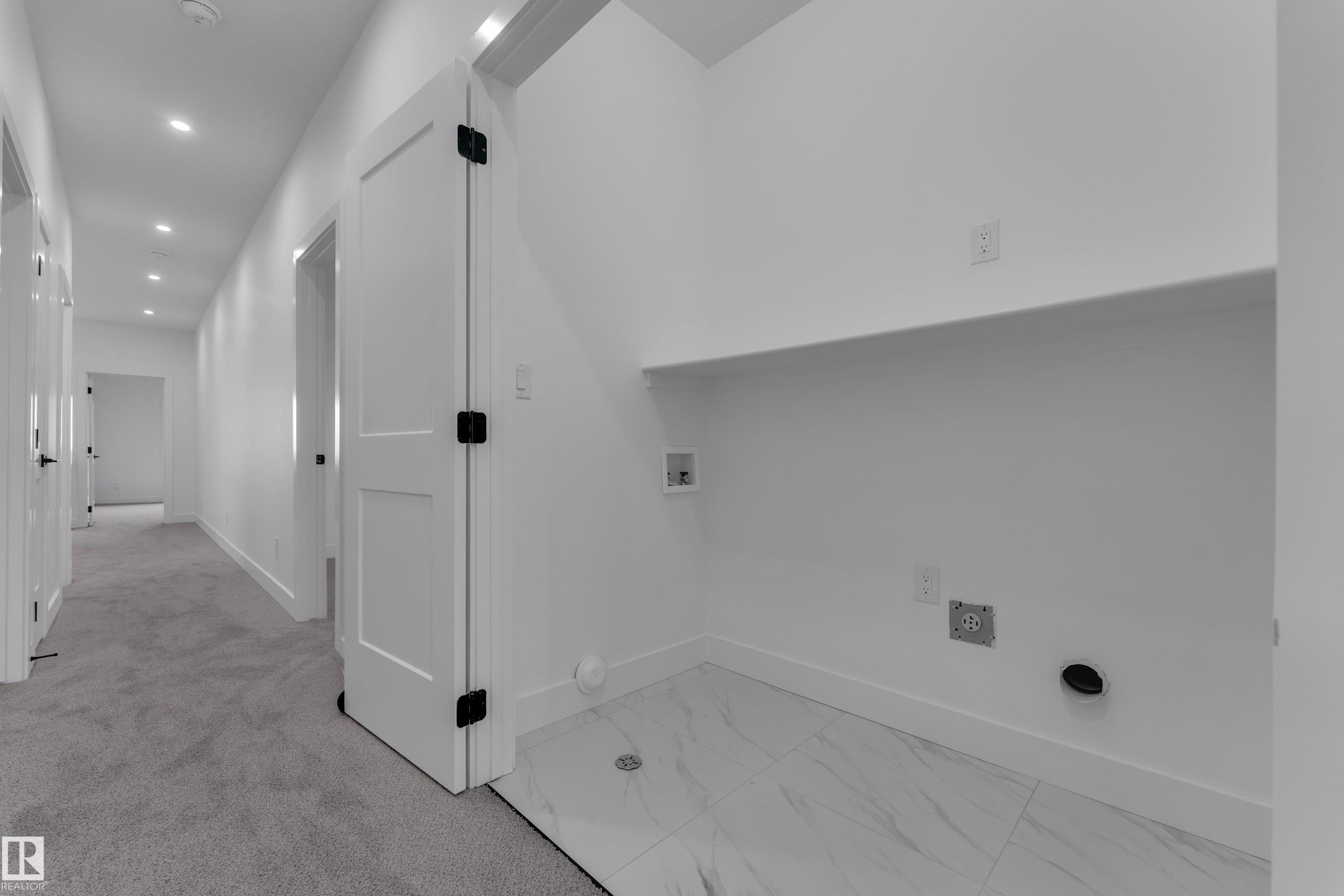 Laundry area featuring white tile flooring, a built-in shelf, and recessed lighting - 794 Bank Drive, Leduc, AB