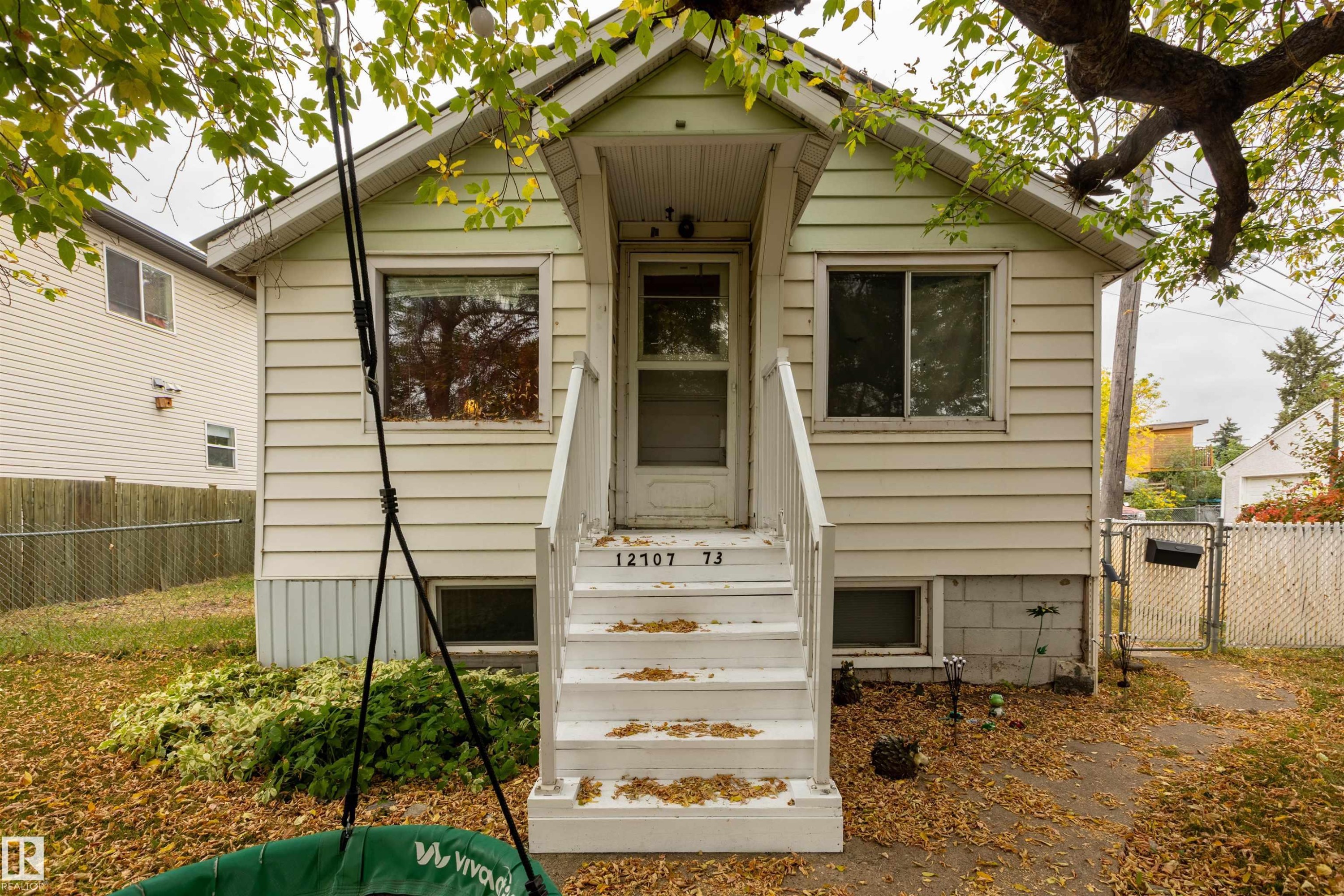 Siding exterior with front porch and white railings - 12707 73 Street Nw, Edmonton, AB