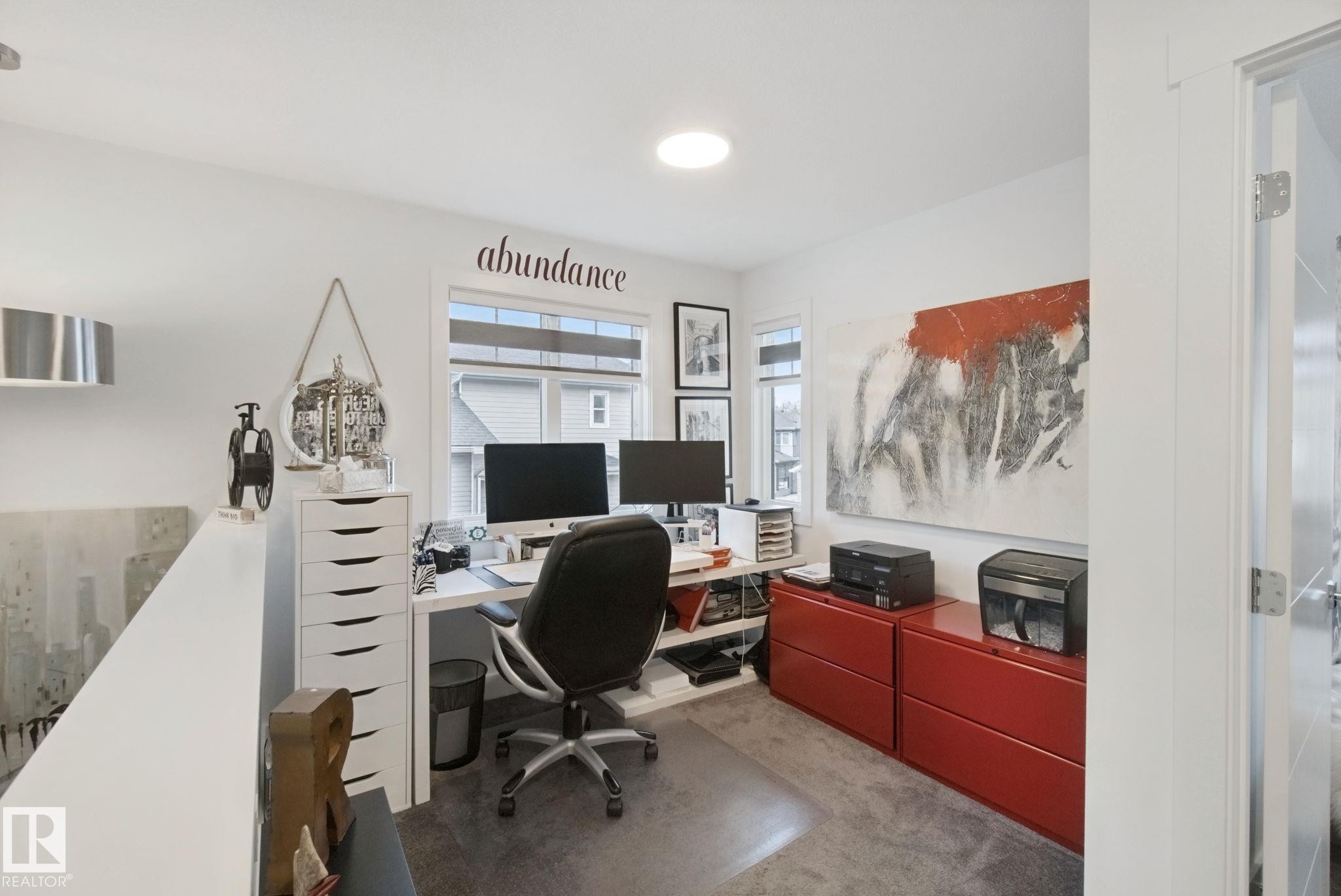 Dedicated workspace featuring expansive windows, recessed lighting, and durable flooring - 153 Cavanagh Common Sw, Edmonton, AB
