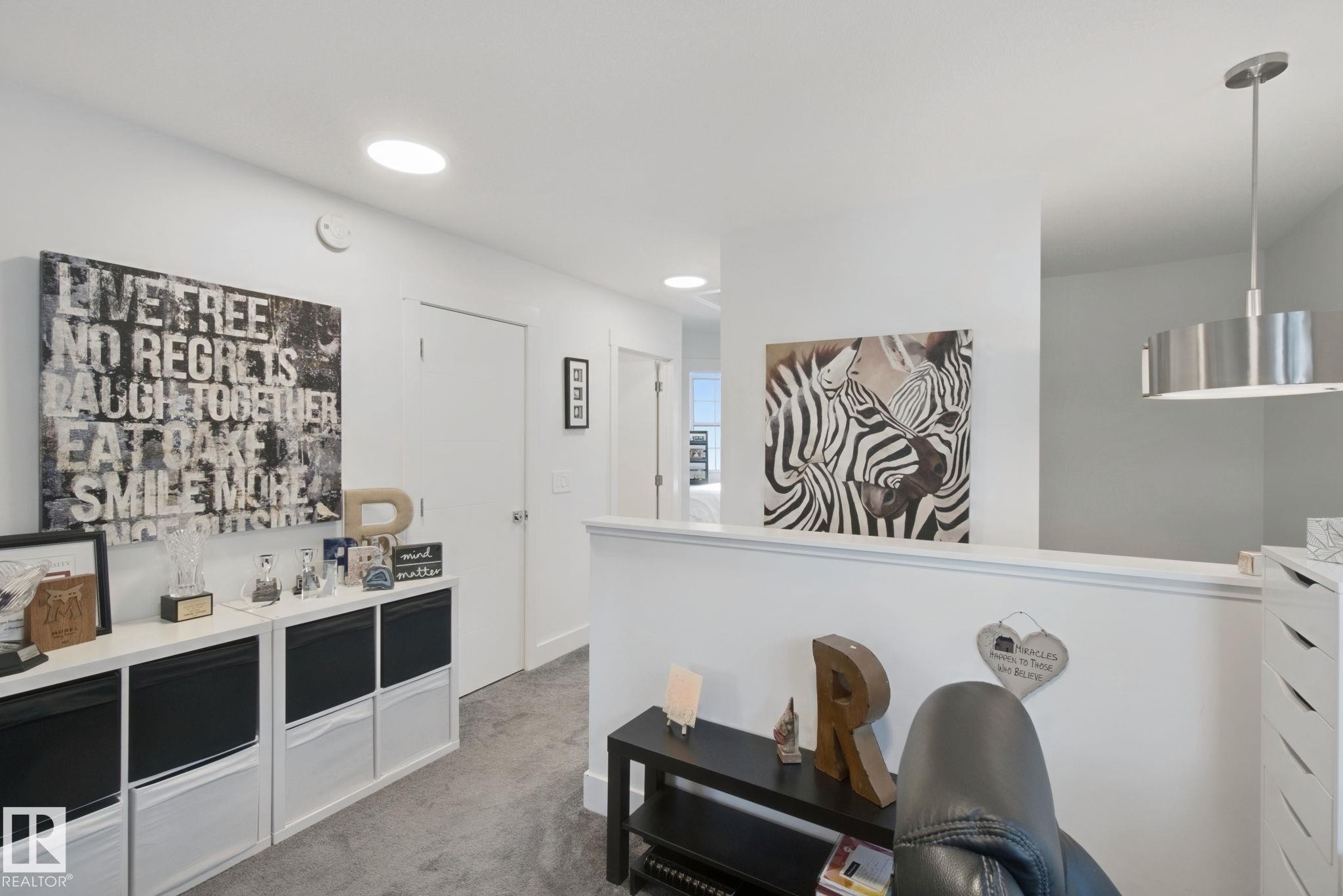Recessed ceiling lighting, durable flooring, white walls, and a contemporary pendant light fixture - 153 Cavanagh Common Sw, Edmonton, AB