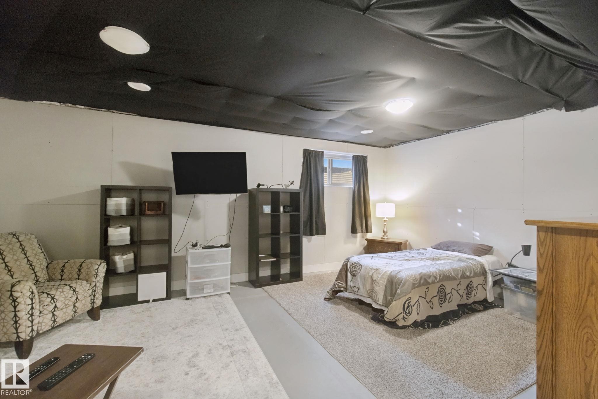 Recessed ceiling lighting, flush mount lighting, painted white walls, wood-finish window trim, and carpeted flooring - 153 Cavanagh Common Sw, Edmonton, AB