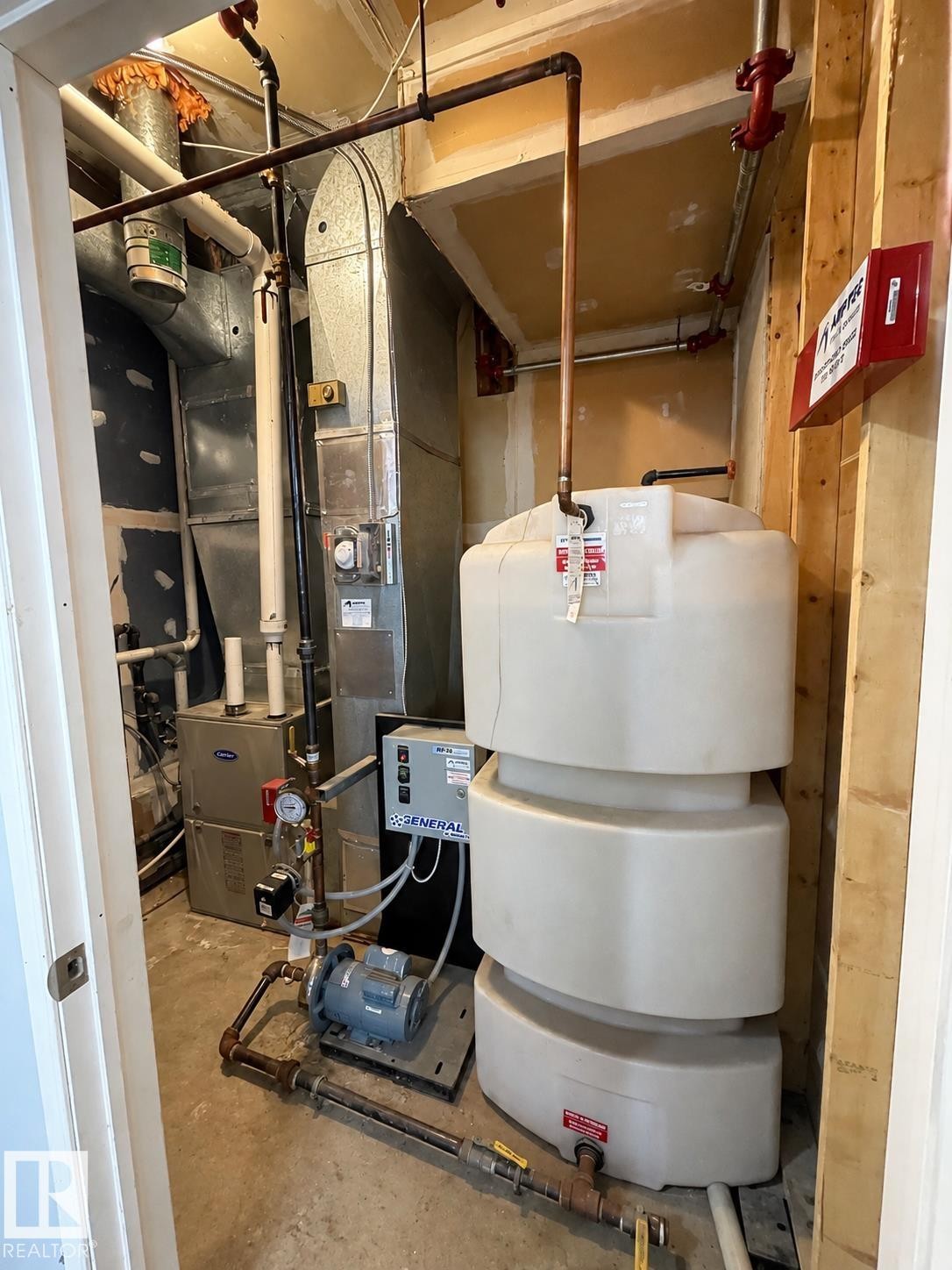 Utility room featuring a water storage tank, HVAC unit, and exposed copper piping - 18929 99A Avenue Nw, Edmonton, AB