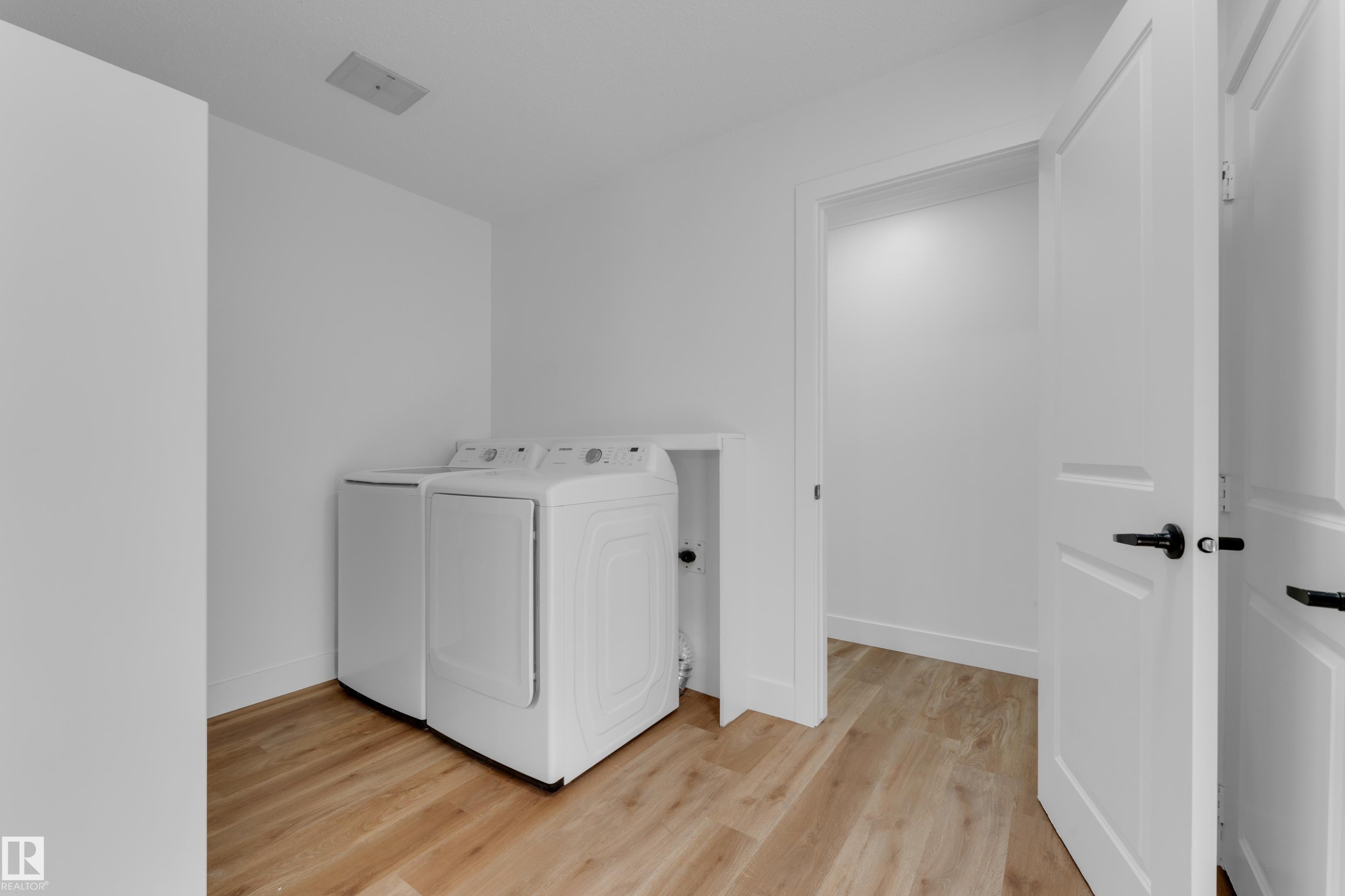 Wood-finish flooring with white walls and trim - 52314 Rge Road 215, Rural Strathcona County, AB