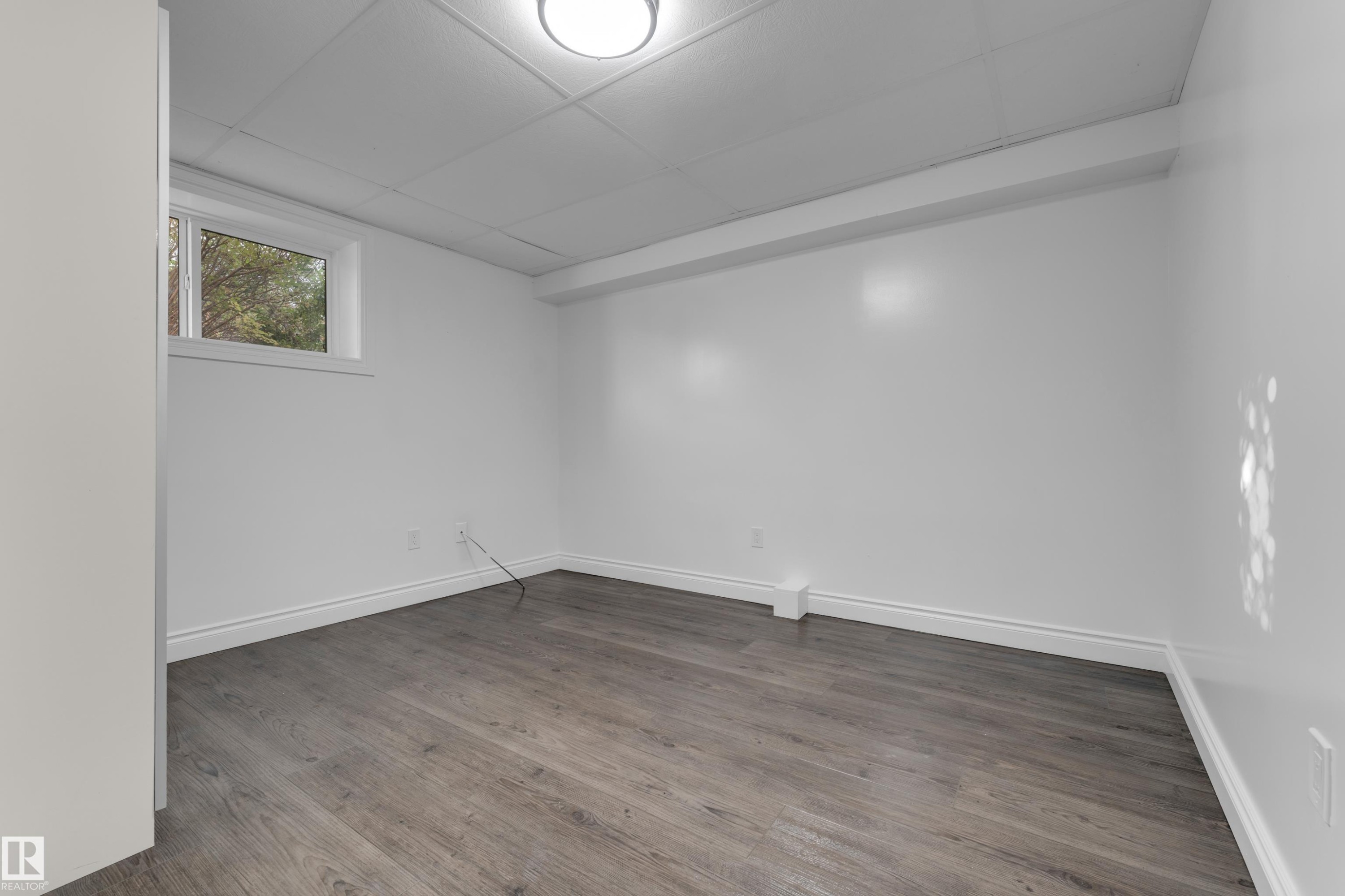 Wood-finish flooring, white walls, and a drop ceiling with recessed lighting - 52314 Rge Road 215, Rural Strathcona County, AB