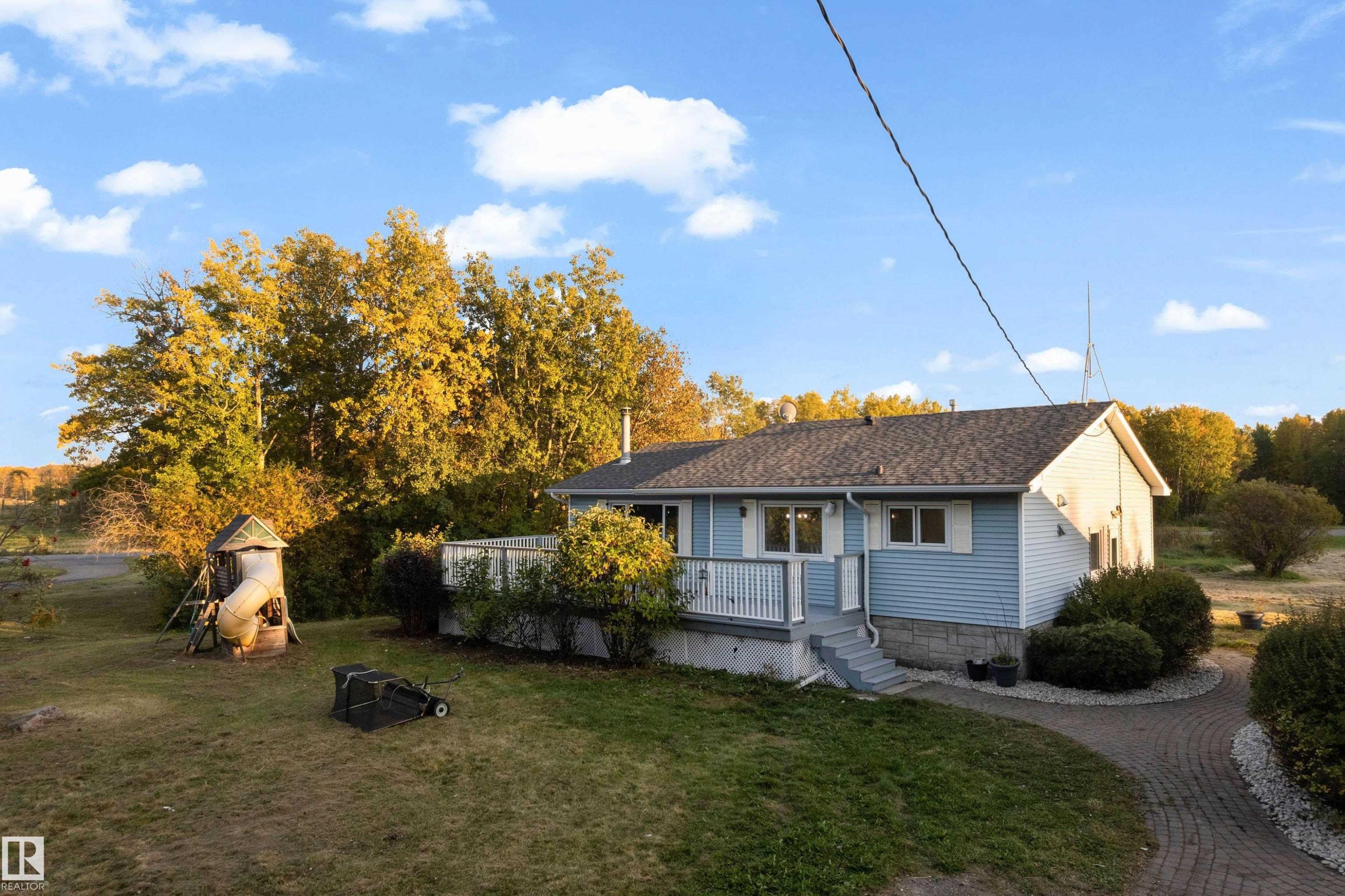 Light blue siding exterior with a dark shingle roof - 52314 Rge Road 215, Rural Strathcona County, AB