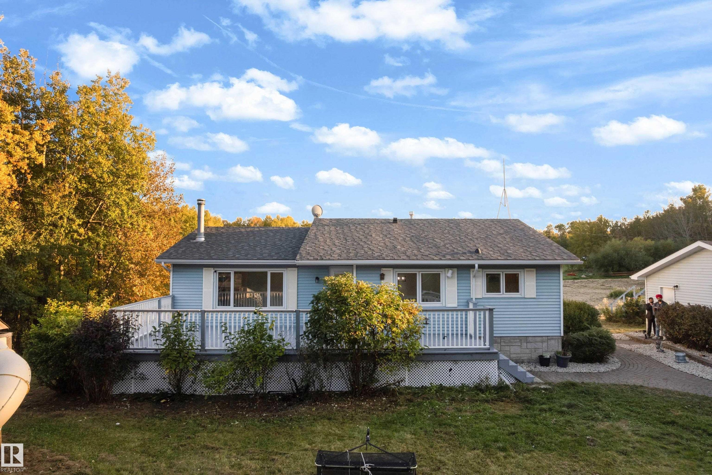 Light blue siding residence with a dark shingle roof - 52314 Rge Road 215, Rural Strathcona County, AB