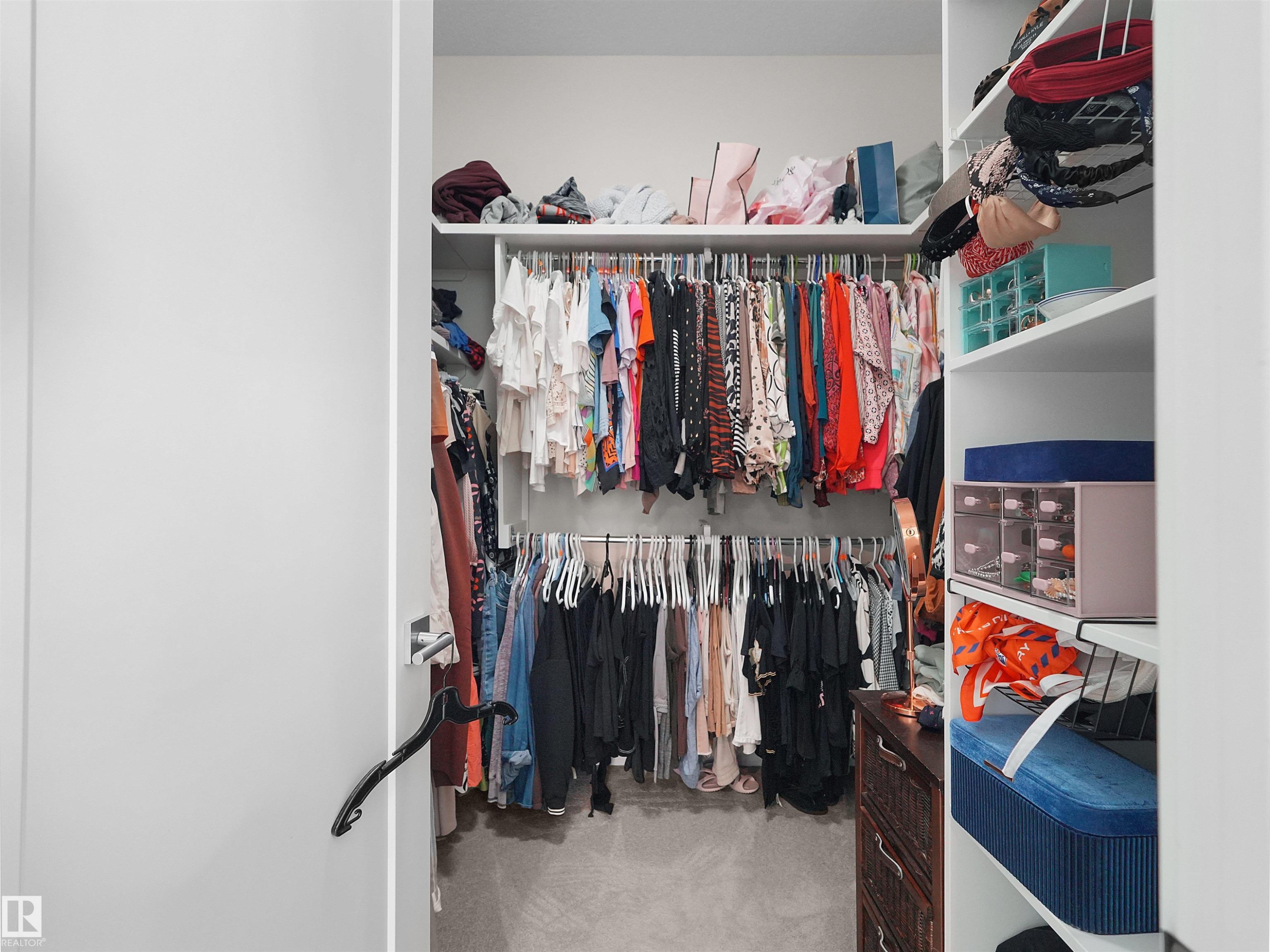 Custom closet system featuring multiple hanging rods and integrated shelving - 904 Wood Place Nw, Edmonton, AB