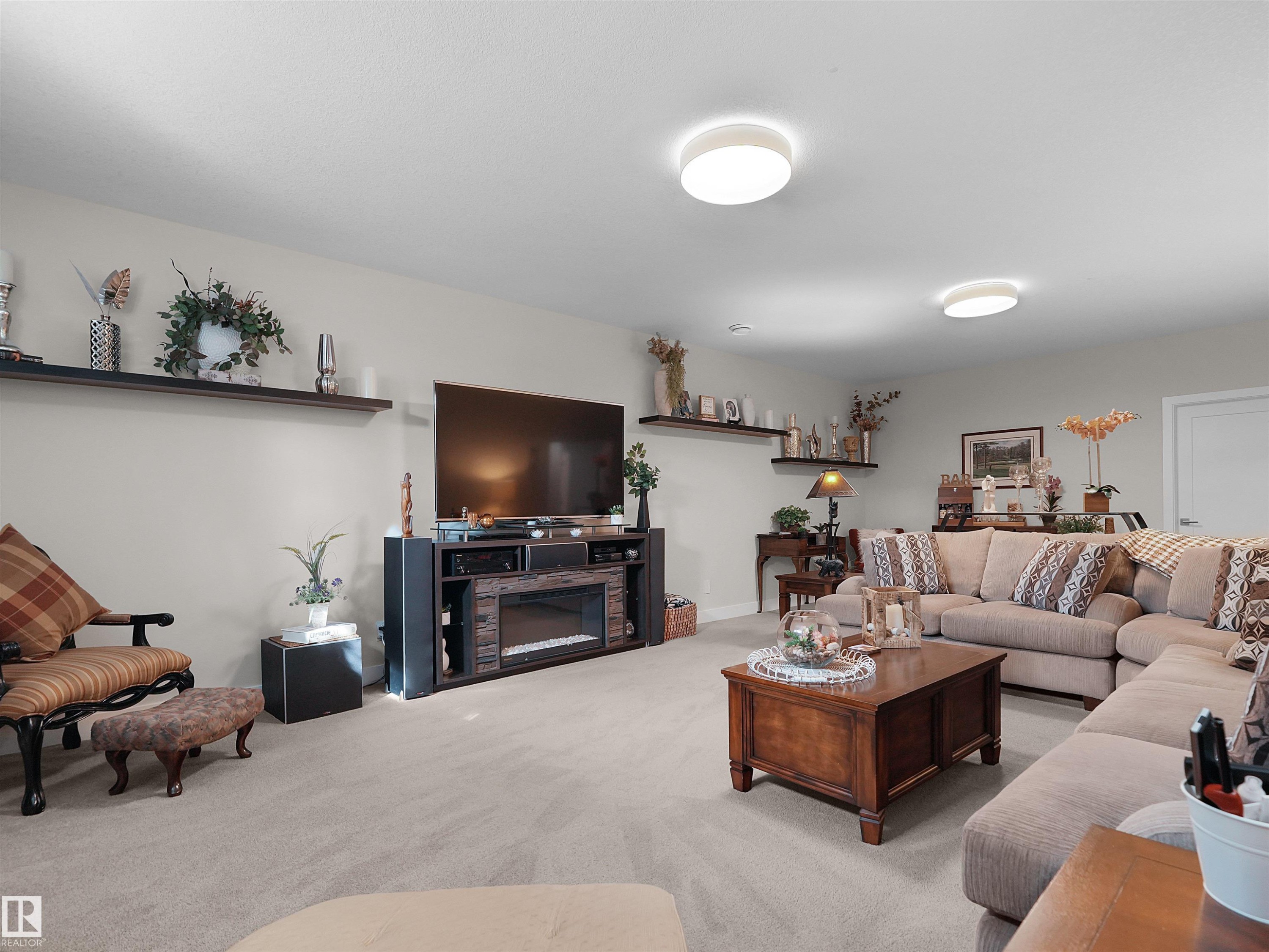 Recessed lighting, wall-mounted shelving, built-in entertainment center, and integrated electric fireplace - 904 Wood Place Nw, Edmonton, AB