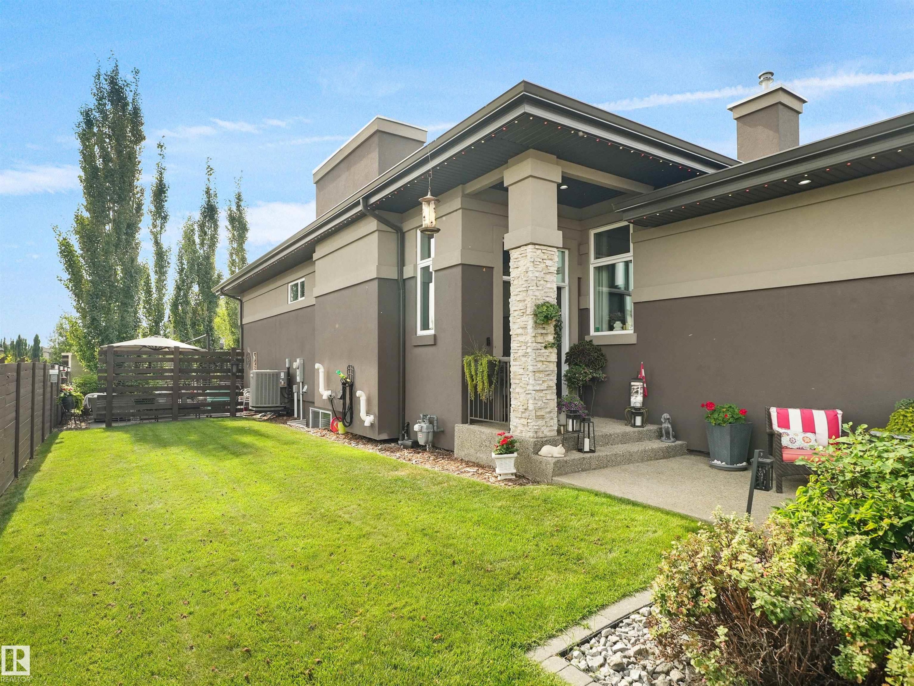 Stucco exterior with stone accent columns, covered entryway, and concrete steps - 904 Wood Place Nw, Edmonton, AB