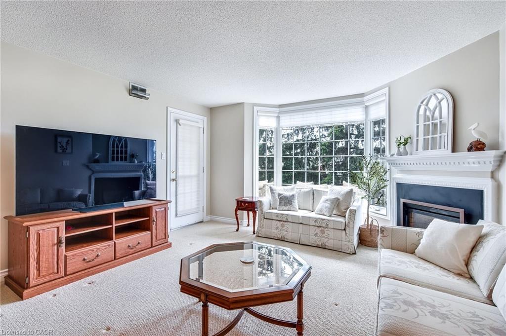 205-970 Golf Links Road, Ancaster, ON - Indoor Photo Showing Living Room With Fireplace
