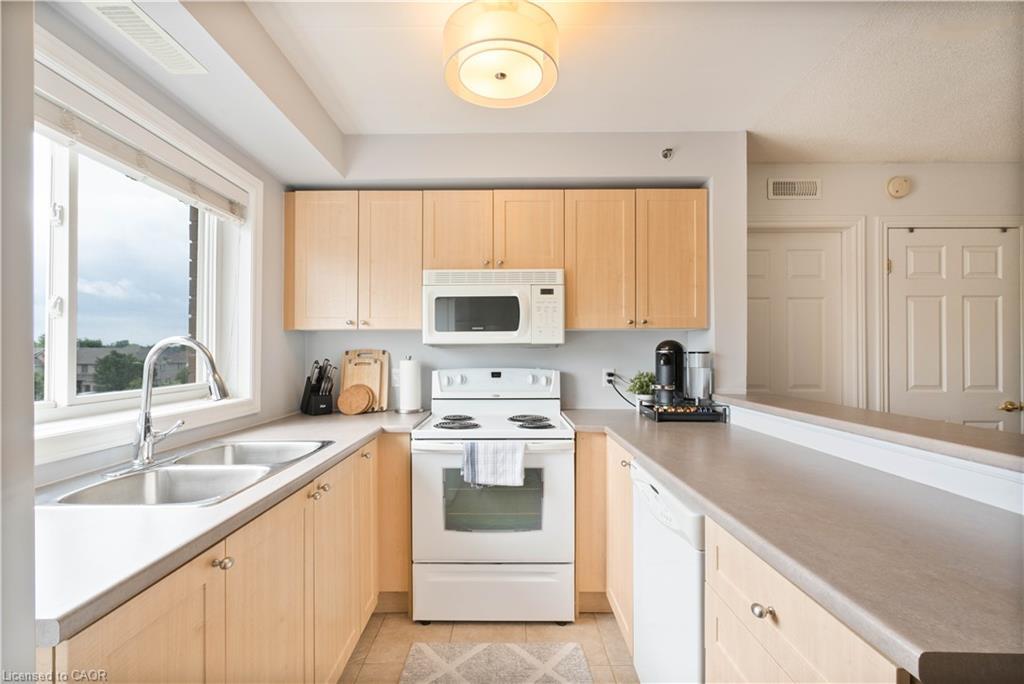 304-4450 Fairview Street, Burlington, ON - Indoor Photo Showing Kitchen With Double Sink