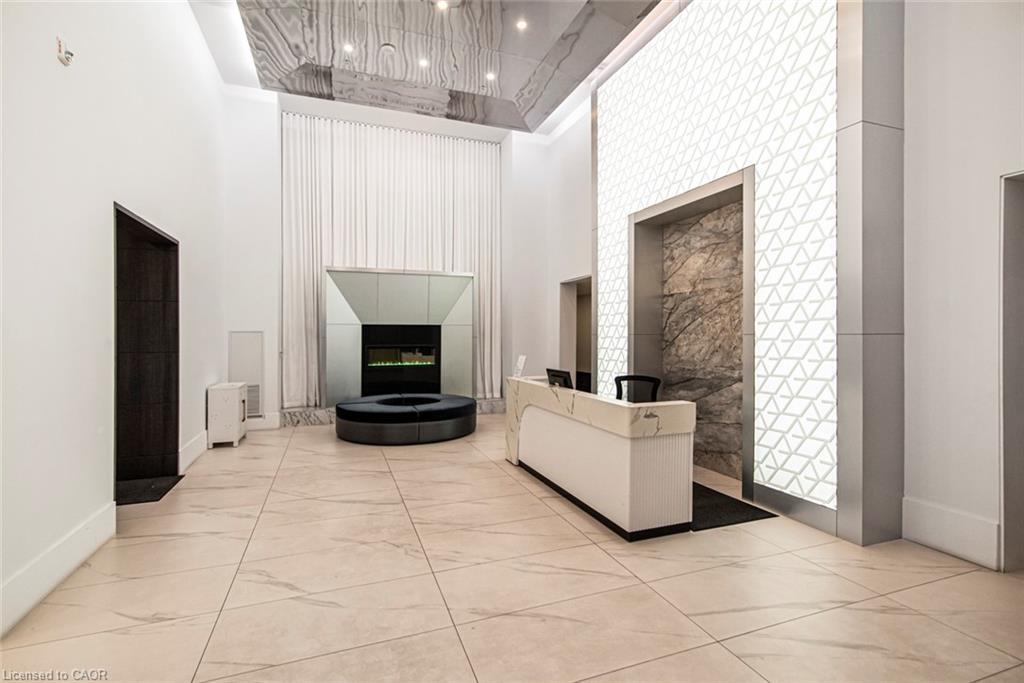 120-16 Concord Place, Grimsby, ON - Indoor Photo Showing Other Room With Fireplace